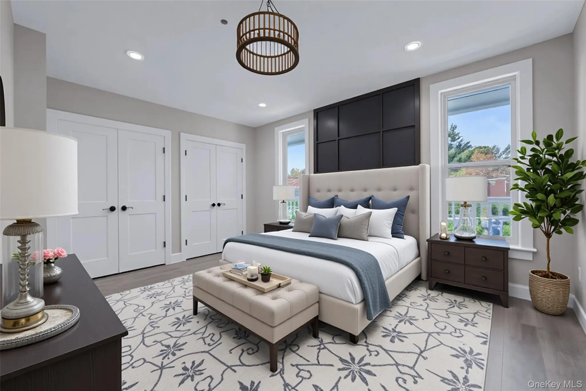 Bedroom featuring multiple closets, light wood-type flooring, multiple windows, and recessed lighting Bedroom featuring multiple closets, light wood-type flooring, multiple windows, and recessed lighting