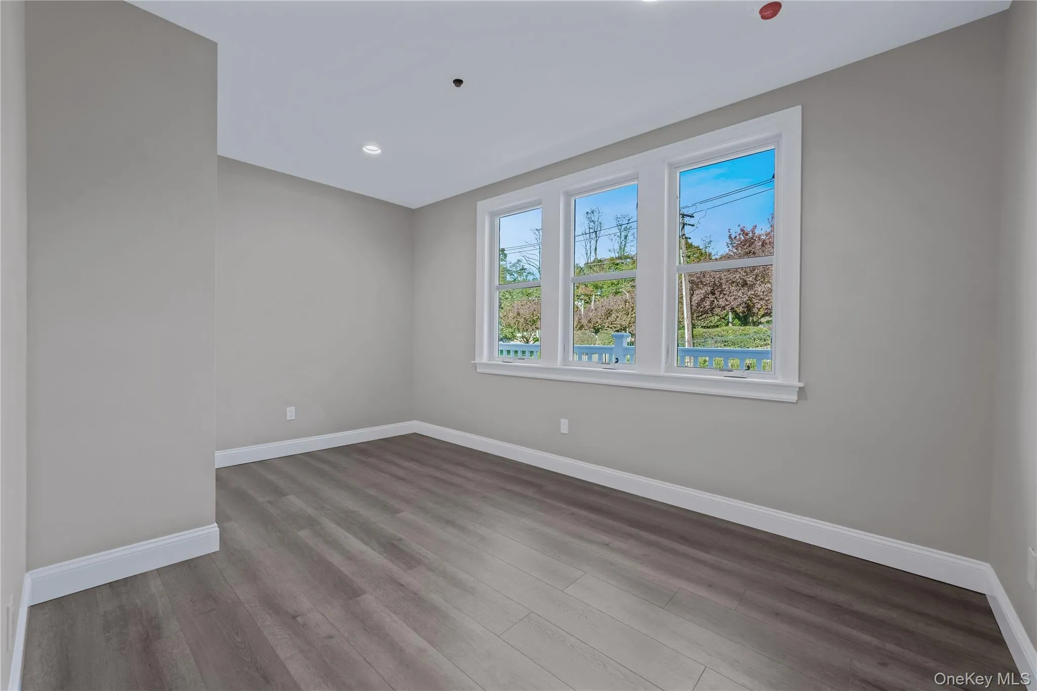 Unfurnished room with light wood-type flooring and recessed lighting Unfurnished room with light wood-type flooring and recessed lighting