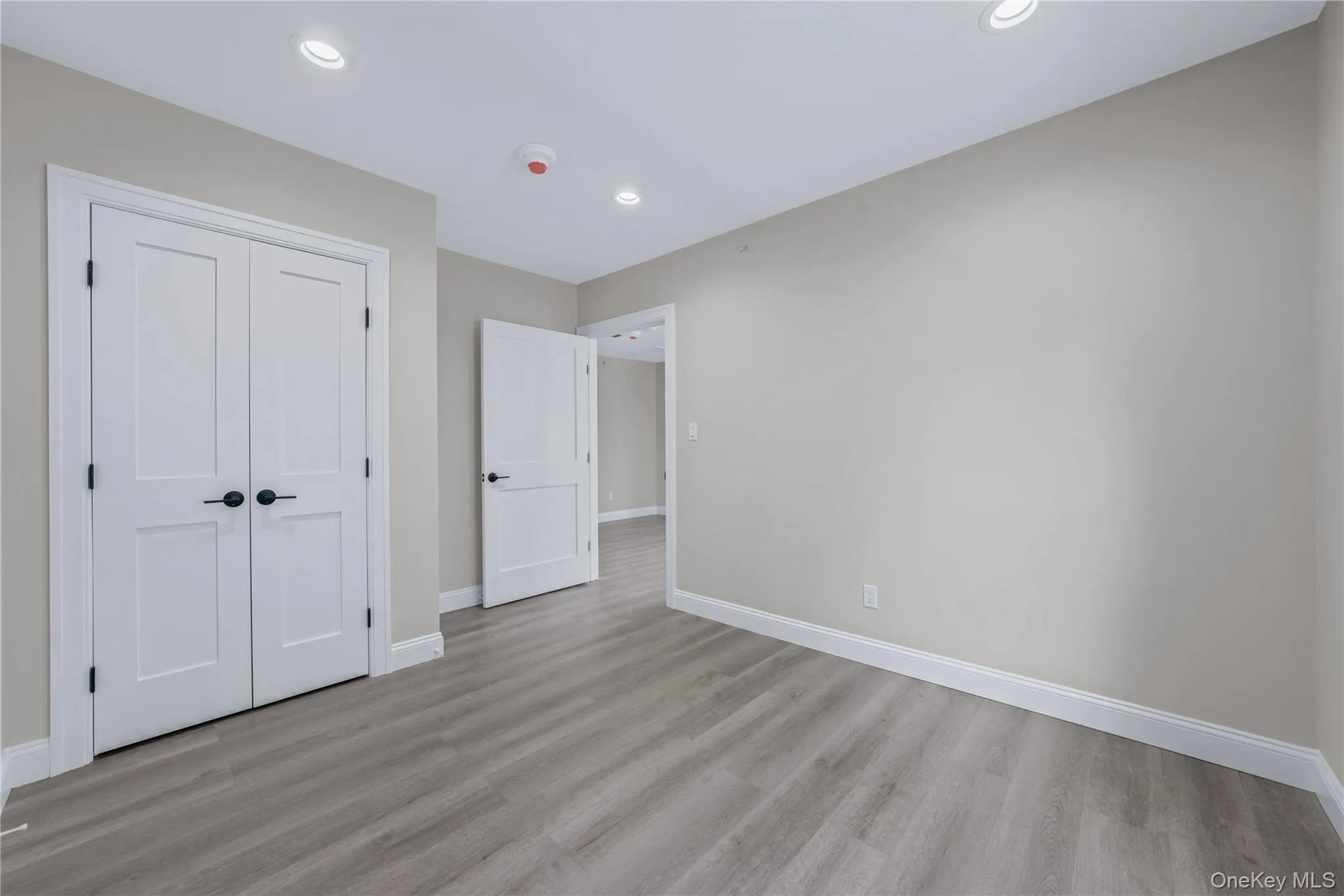 Unfurnished bedroom featuring light wood finished floors, a closet, and recessed lighting Unfurnished bedroom featuring light wood finished floors, a closet, and recessed lighting