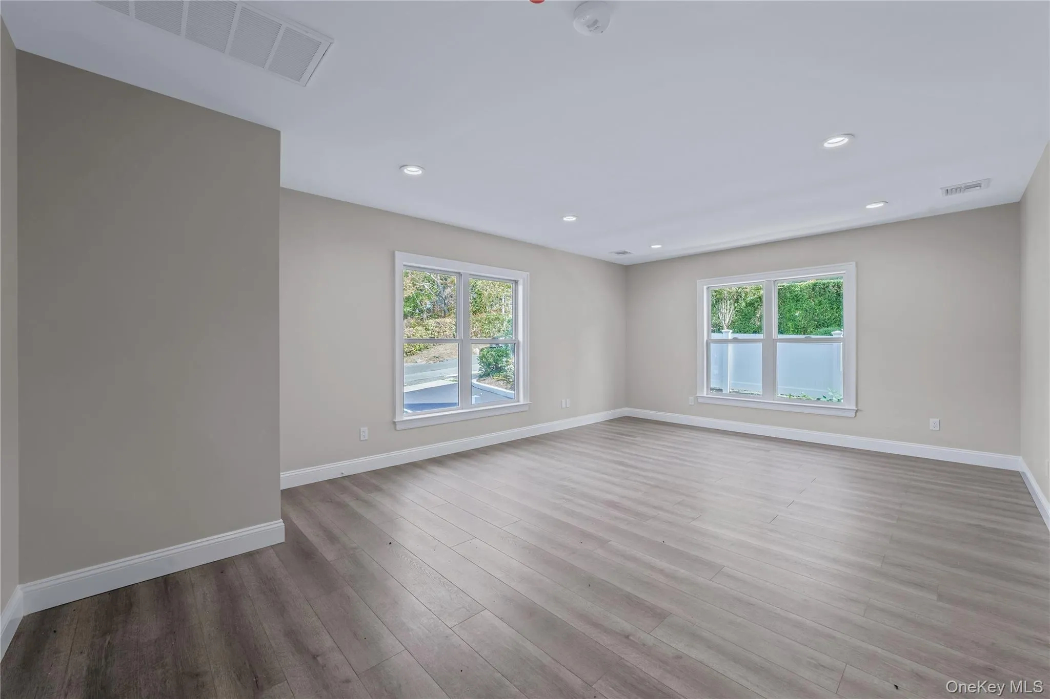 Spare room with light wood-style floors and recessed lighting Spare room with light wood-style floors and recessed lighting
