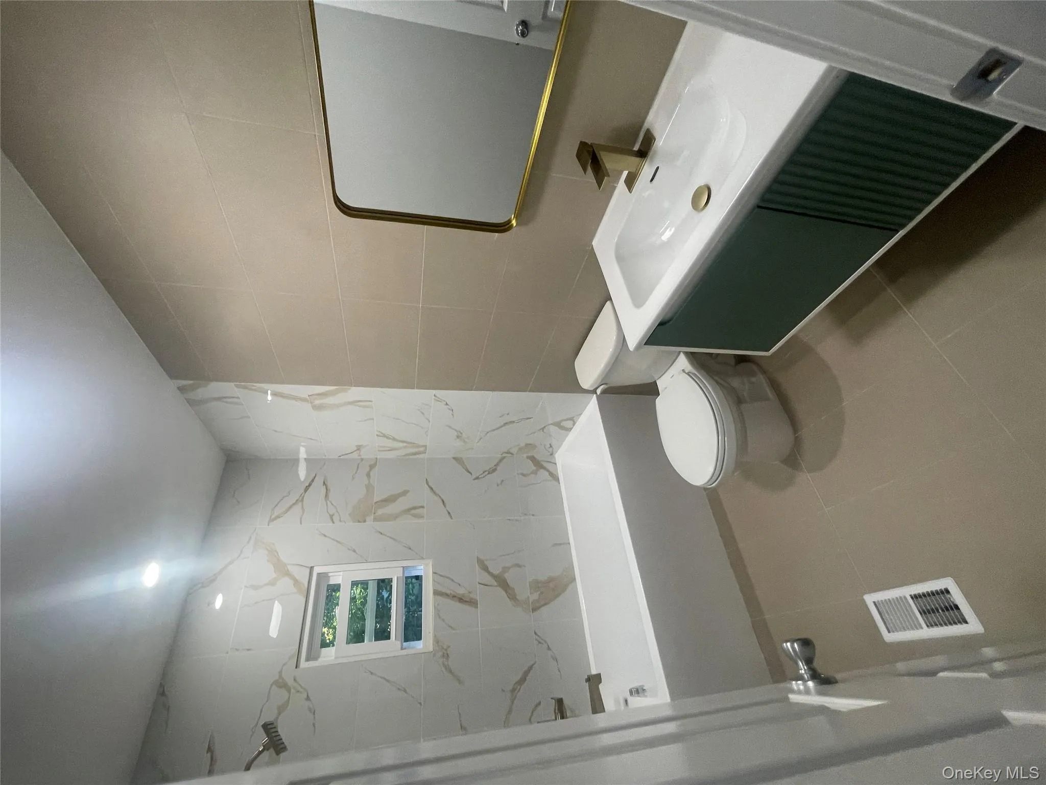 MAIN Bathroom 2 featuring tile walls, vanity, tile patterned flooring, and shower / bath combination MAIN Bathroom 2 featuring tile walls, vanity, tile patterned flooring, and shower / bath combination