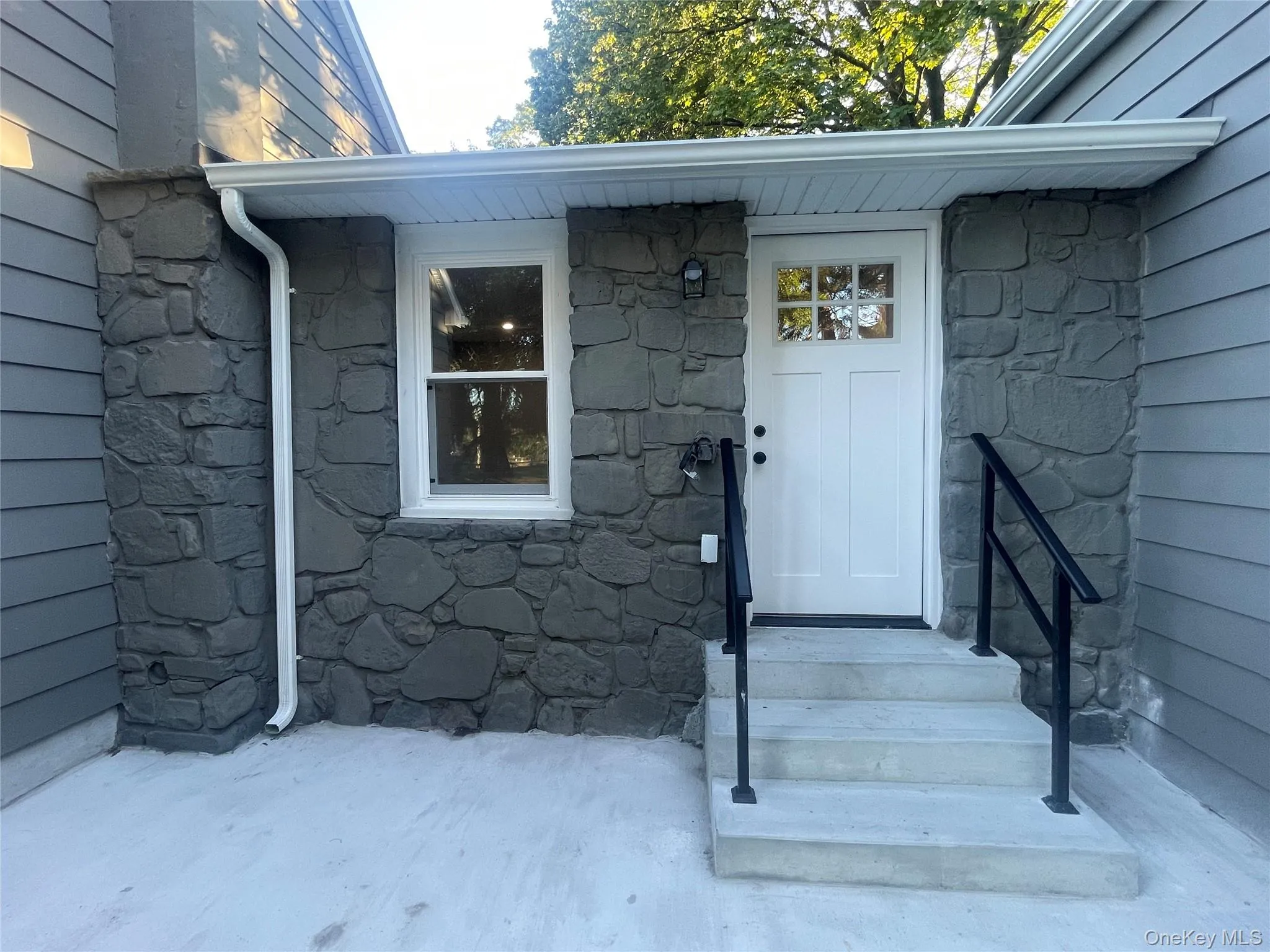 Property entrance featuring stone siding Property entrance featuring stone siding