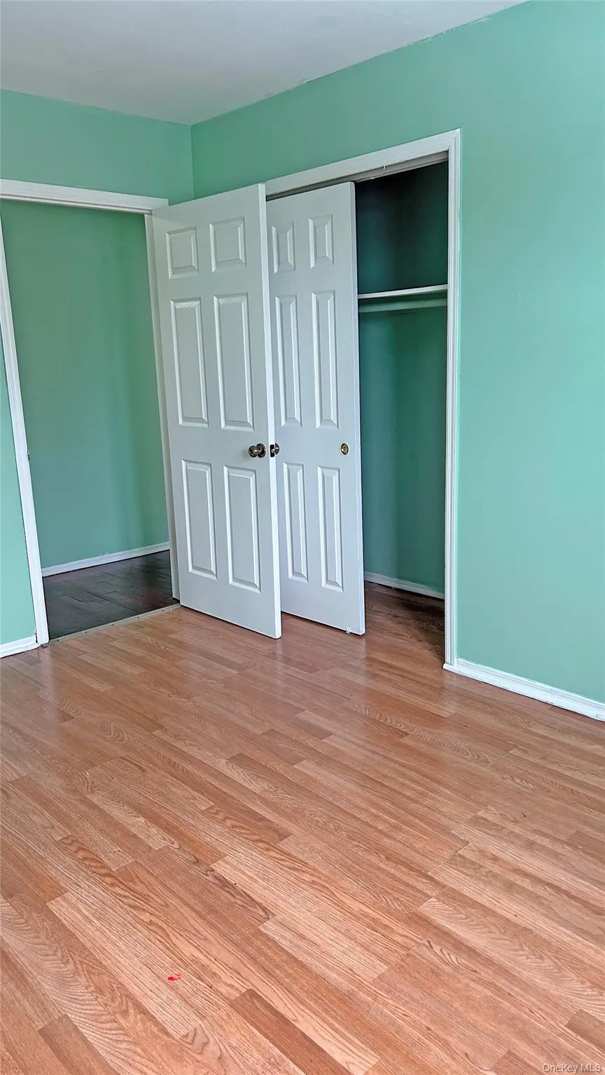Unfurnished bedroom featuring a closet and light wood-type flooring Unfurnished bedroom featuring a closet and light wood-type flooring