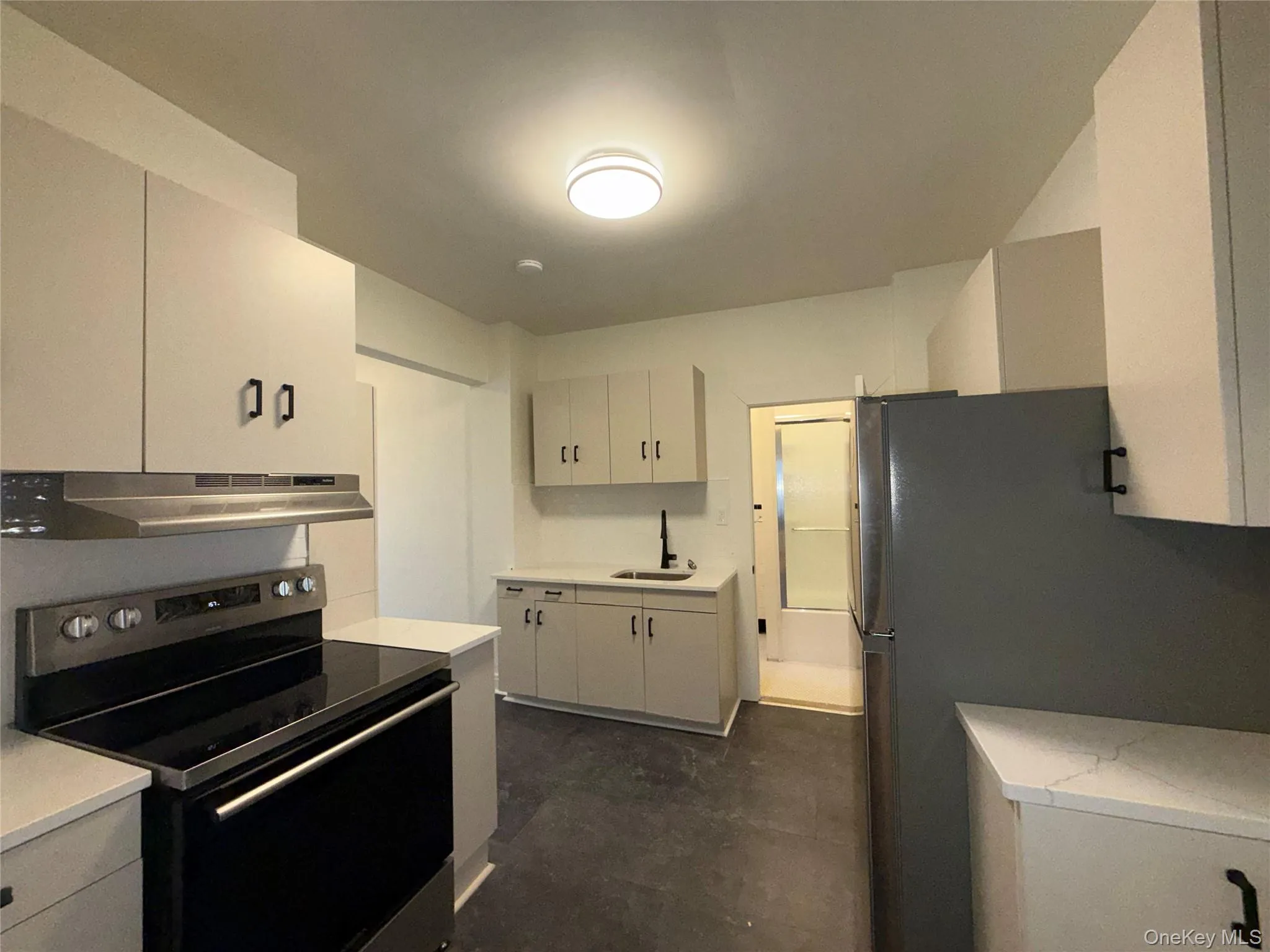 Kitchen with stainless steel appliances and under cabinet range hood Kitchen with stainless steel appliances and under cabinet range hood