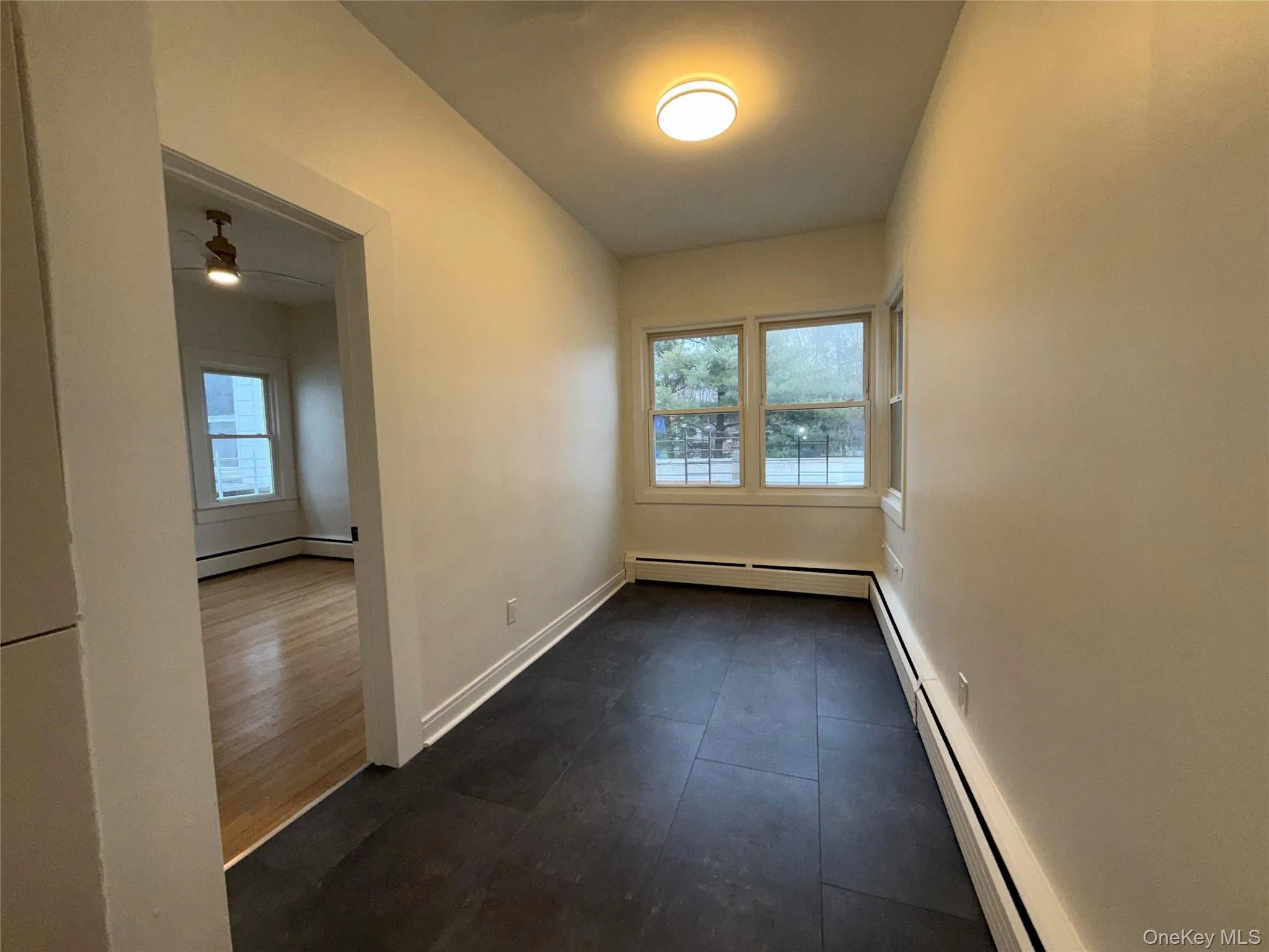 Spare room with baseboard heating and ceiling fan Spare room with baseboard heating and ceiling fan