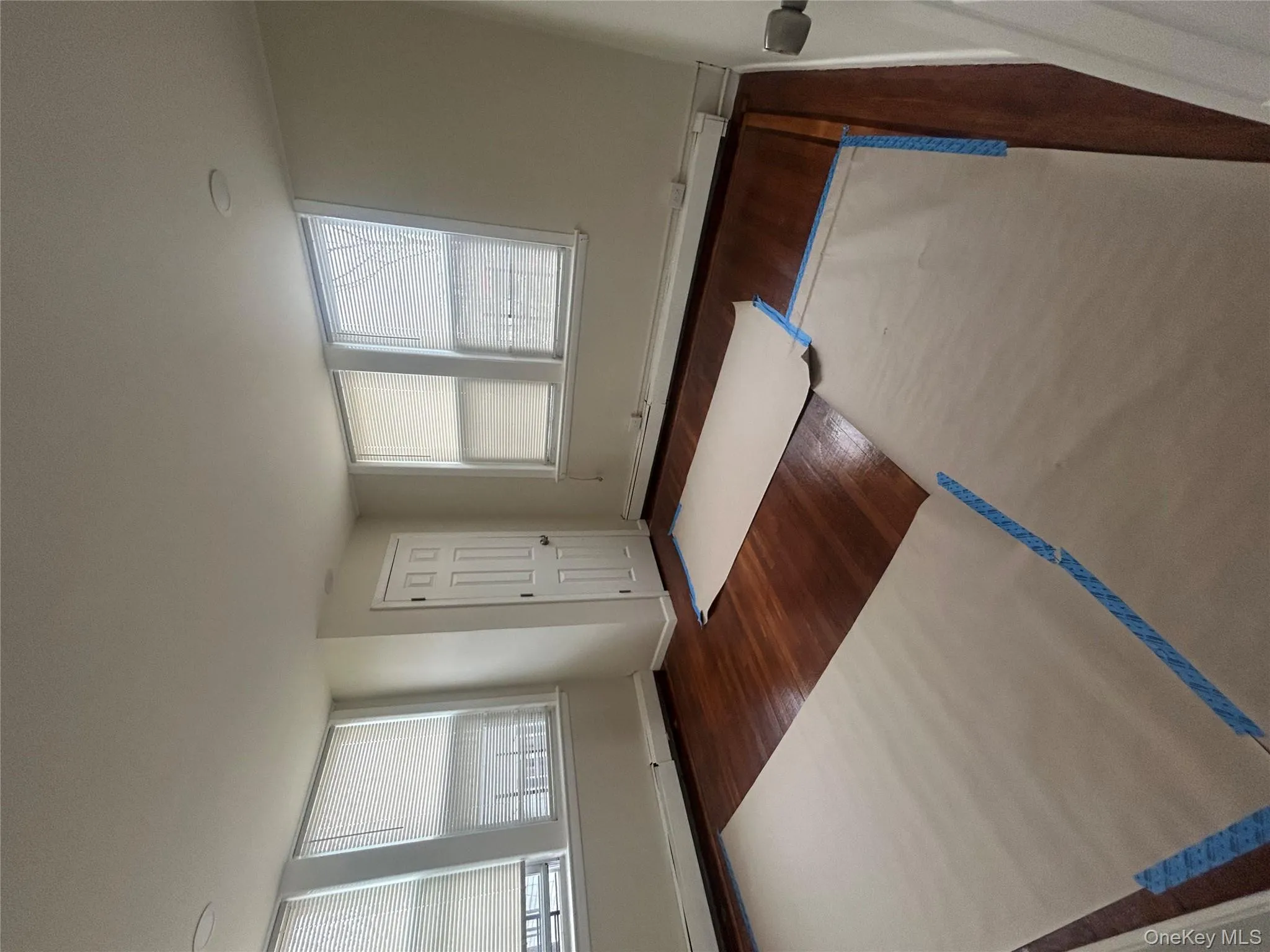 Entryway featuring a baseboard heating unit and dark wood finished floors Entryway featuring a baseboard heating unit and dark wood finished floors