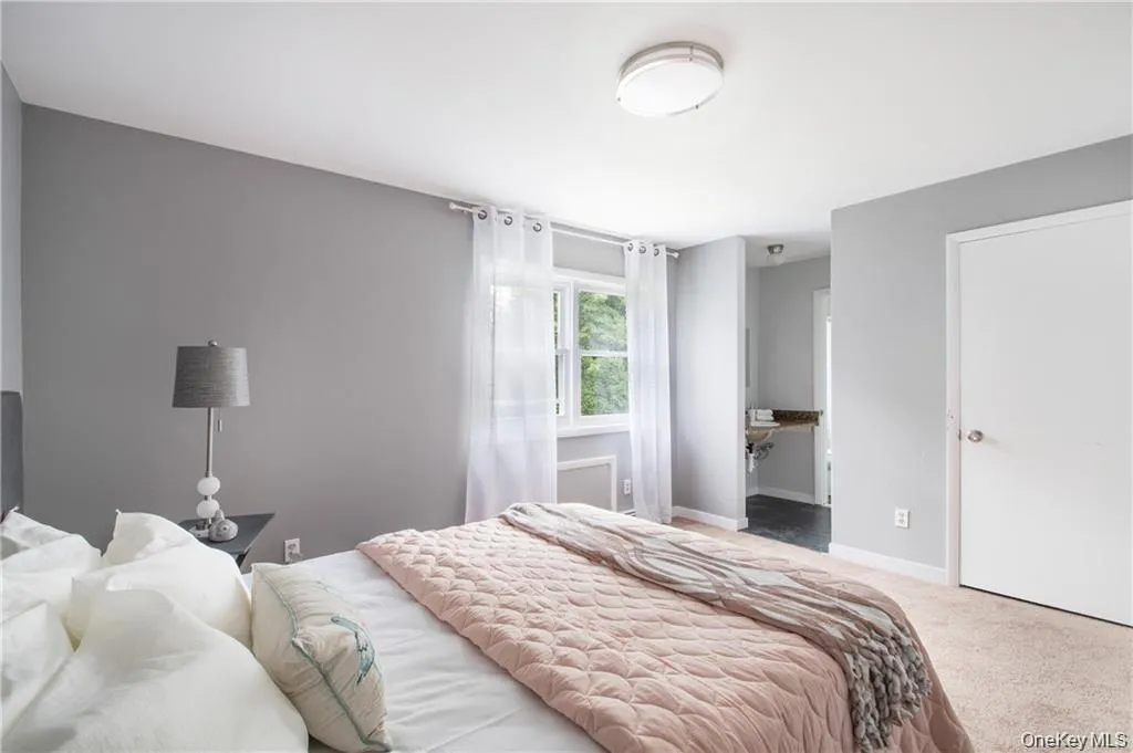 Bedroom featuring carpet flooring and baseboards Bedroom featuring carpet flooring and baseboards