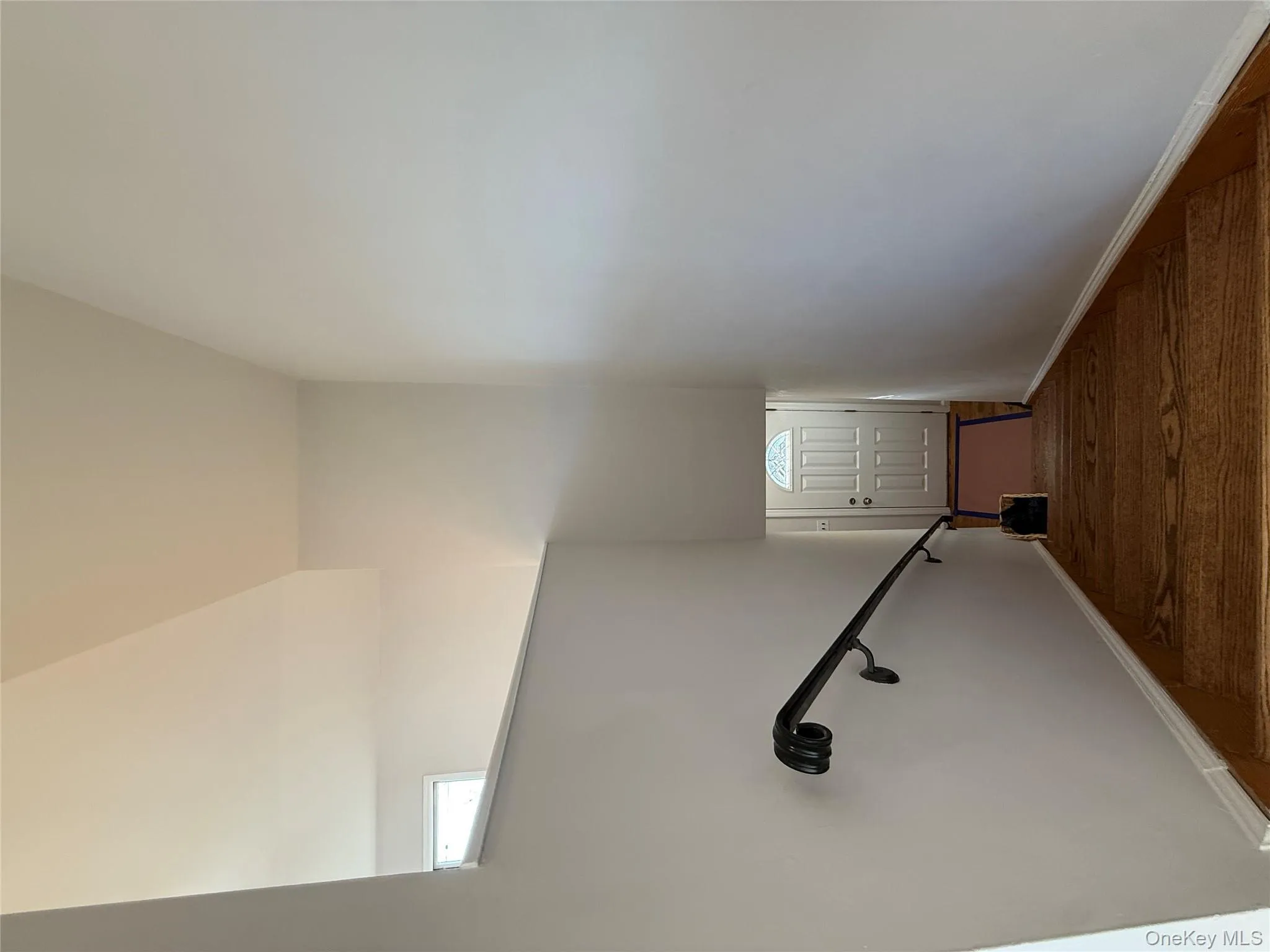 Stairway featuring baseboards and a towering ceiling Stairway featuring baseboards and a towering ceiling