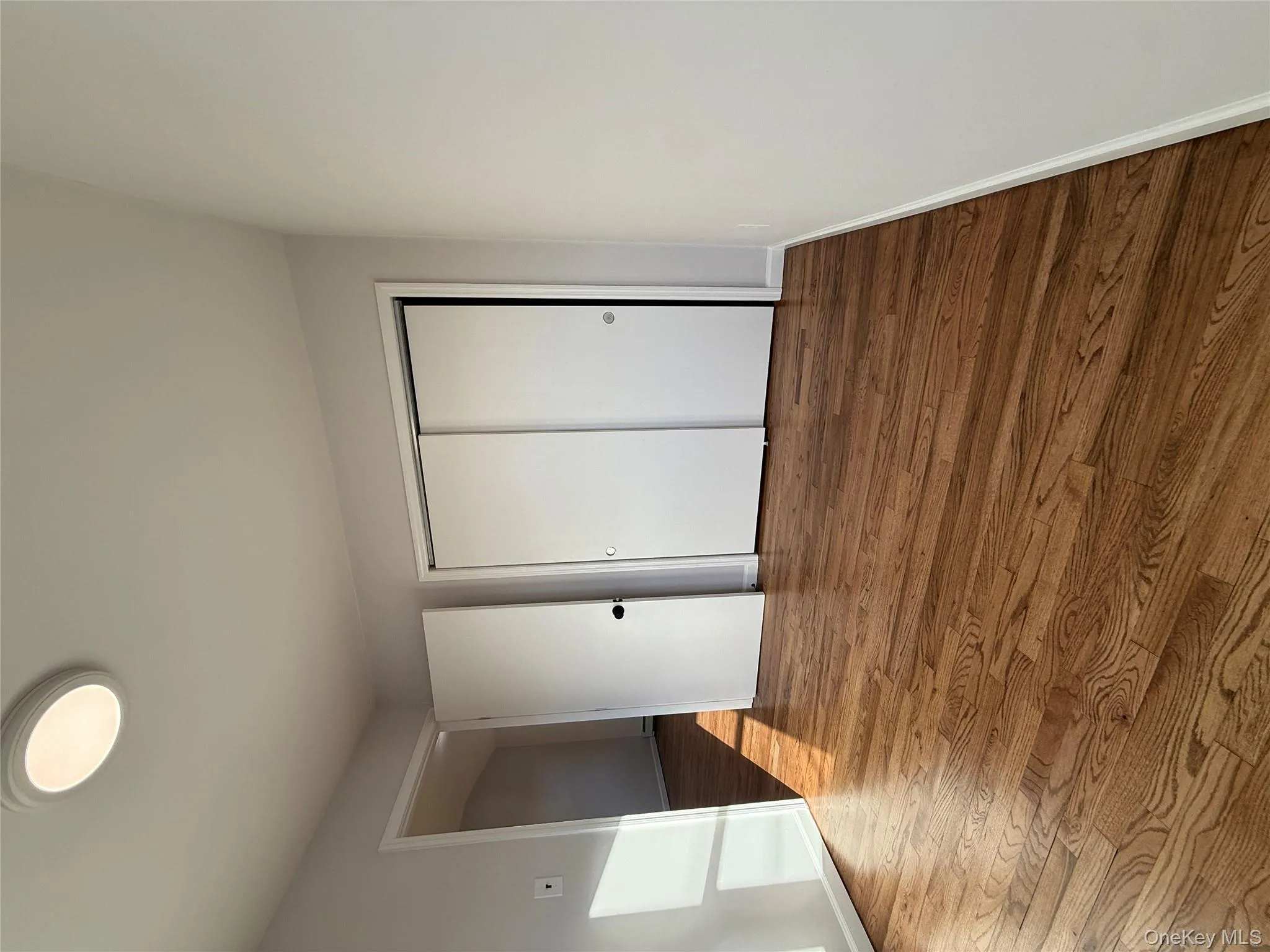 Unfurnished bedroom with a closet and wood finished floors Unfurnished bedroom with a closet and wood finished floors