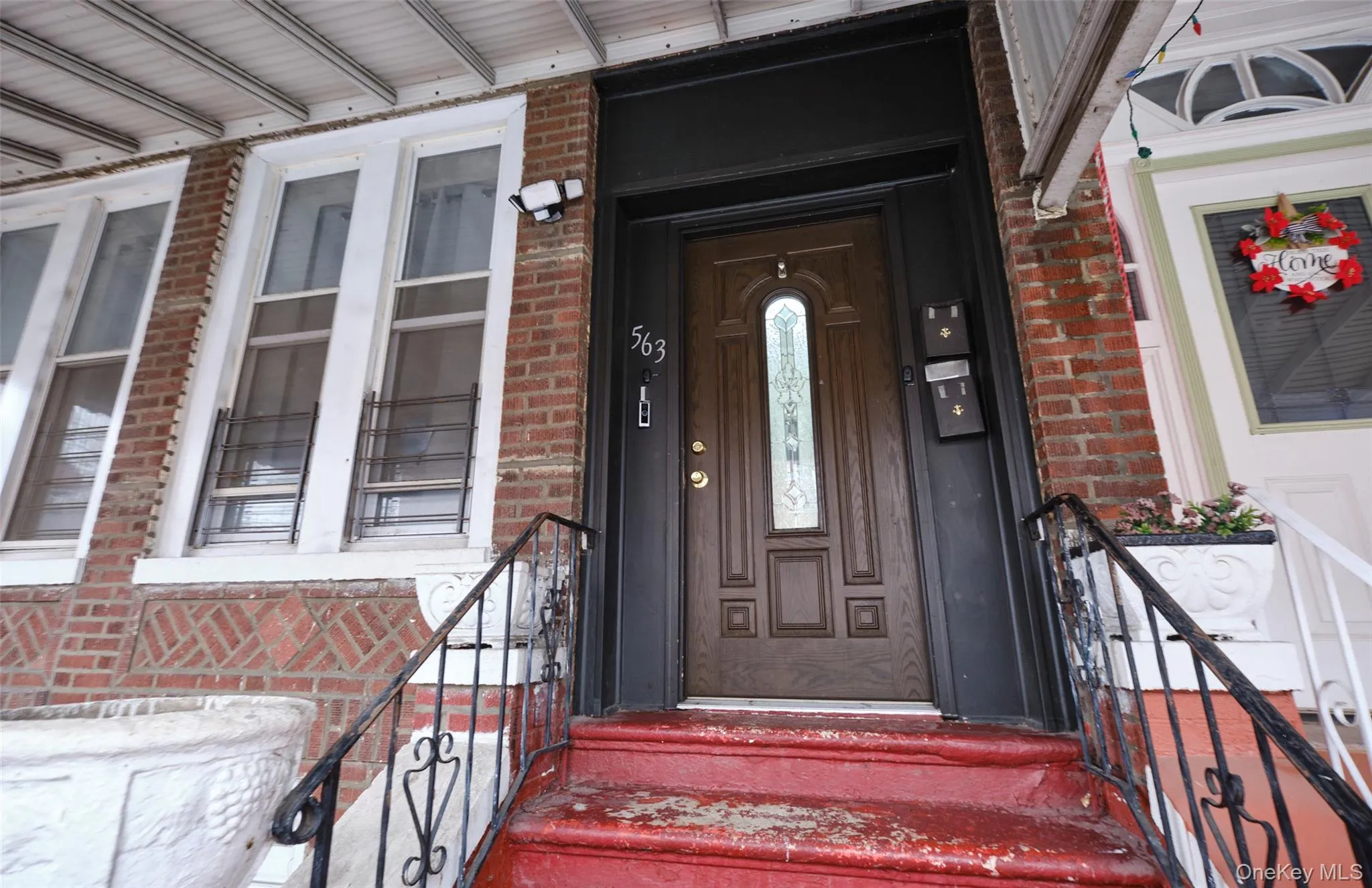 Doorway to property featuring brick siding Doorway to property featuring brick siding