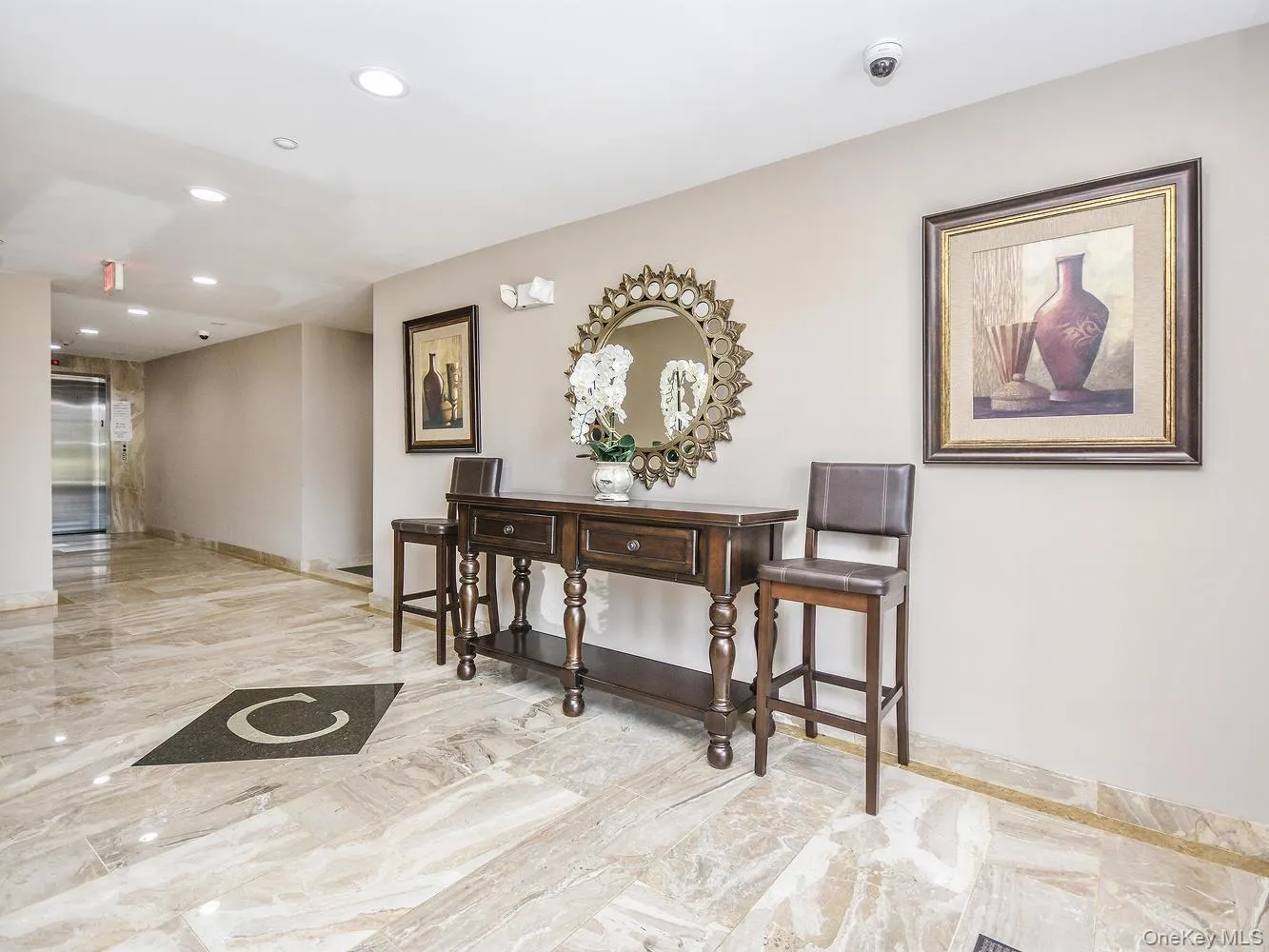 Entryfeaturing recessed lighting, light marble finish flooring, and elevator Entryfeaturing recessed lighting, light marble finish flooring, and elevator