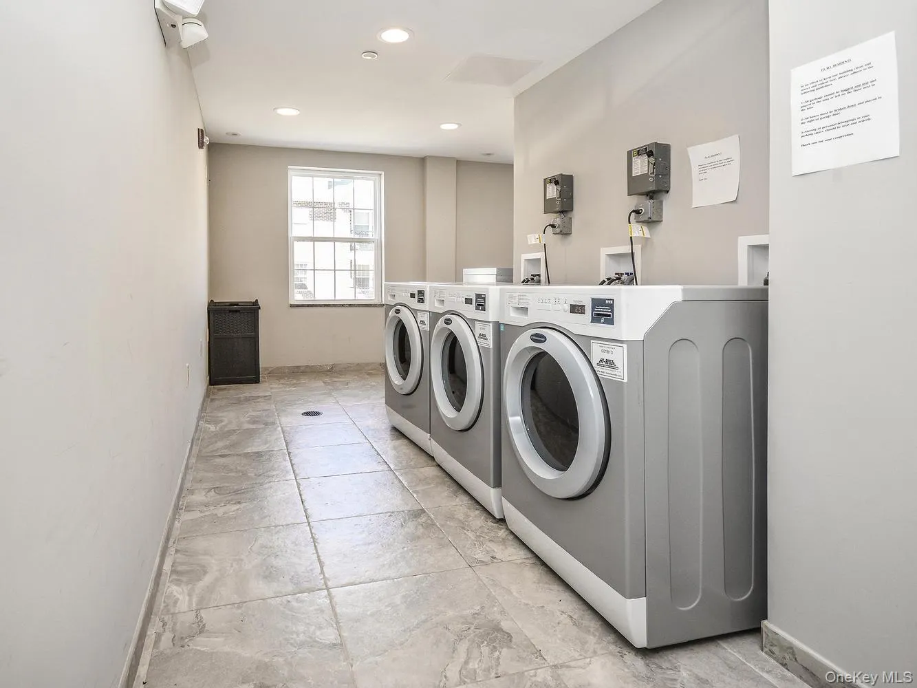 Community laundry with washing machine and dryer and recessed lighting Community laundry with washing machine and dryer and recessed lighting