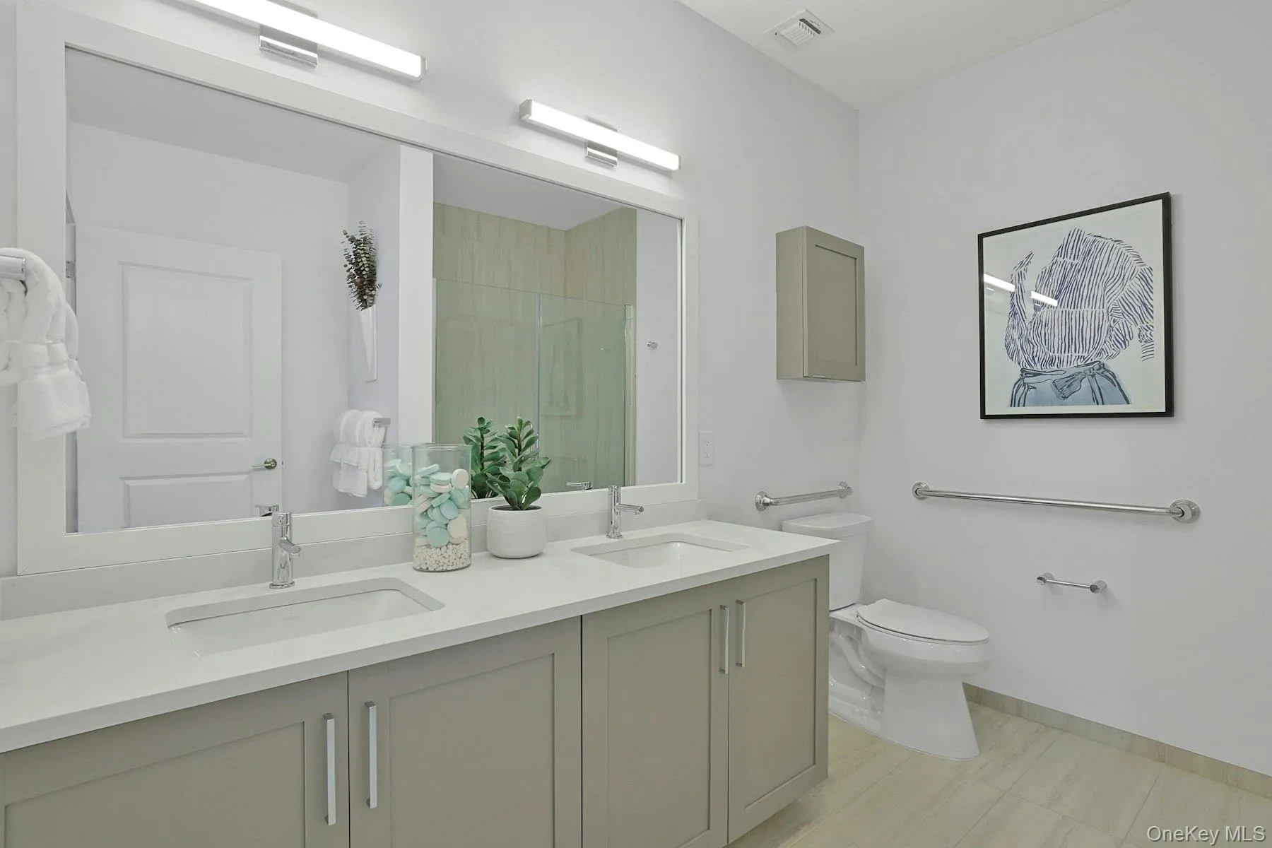 Bathroom featuring double vanity and a shower with door Bathroom featuring double vanity and a shower with door