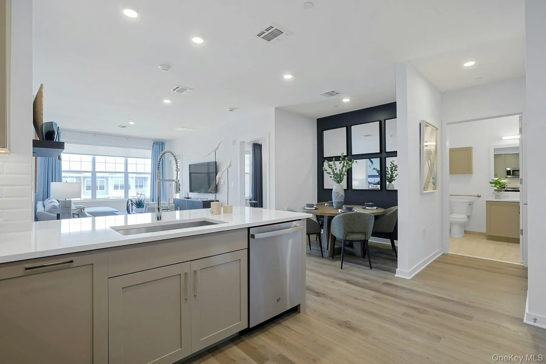 Kitchen featuring stainless steel appliances, open floor plan, Quartz countertops, recessed lighting, and light wood-style floors Kitchen featuring stainless steel appliances, open floor plan, Quartz countertops, recessed lighting, and light wood-style floors