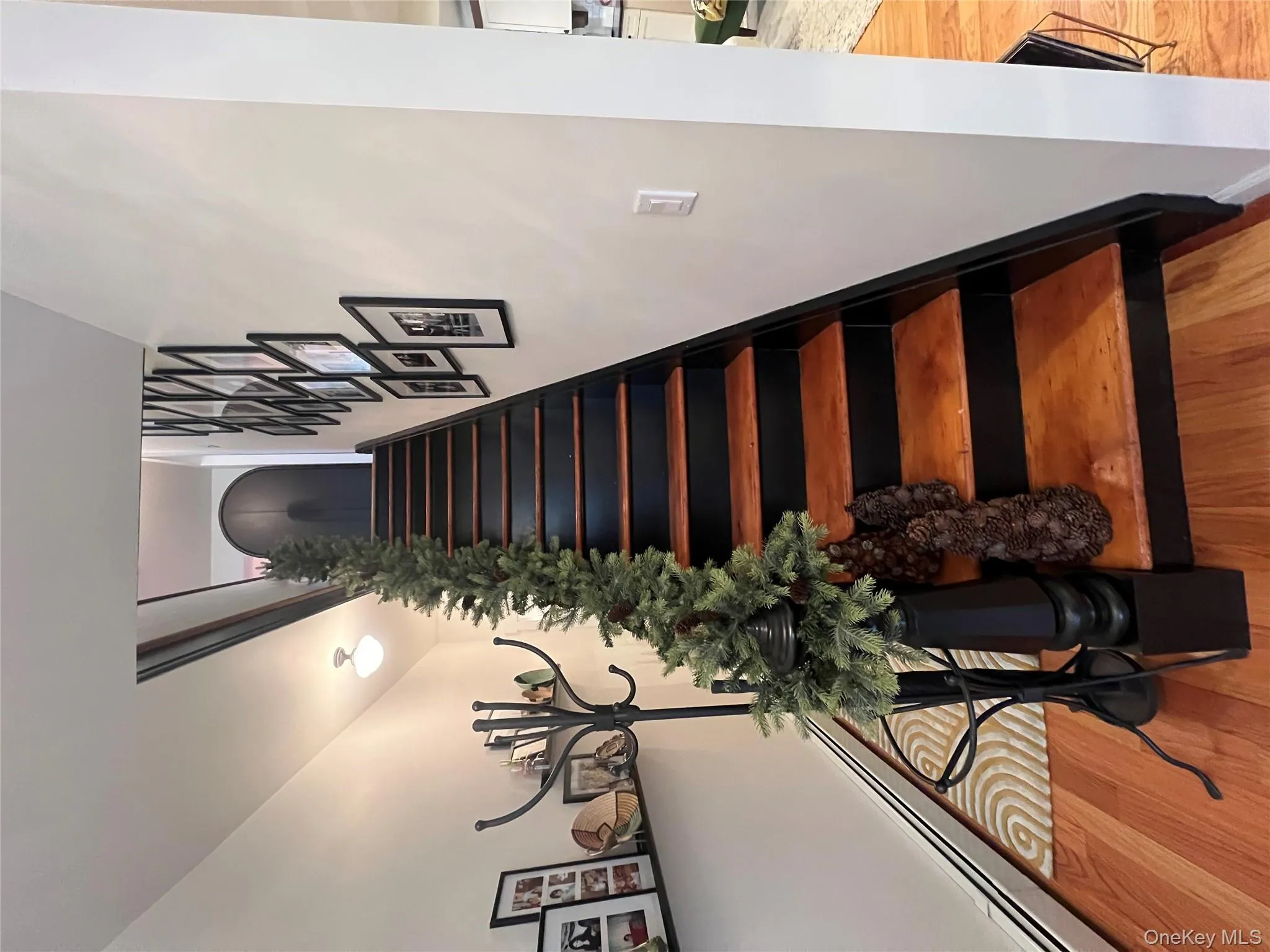 Staircase with baseboard heating and wood finished floors Staircase with baseboard heating and wood finished floors