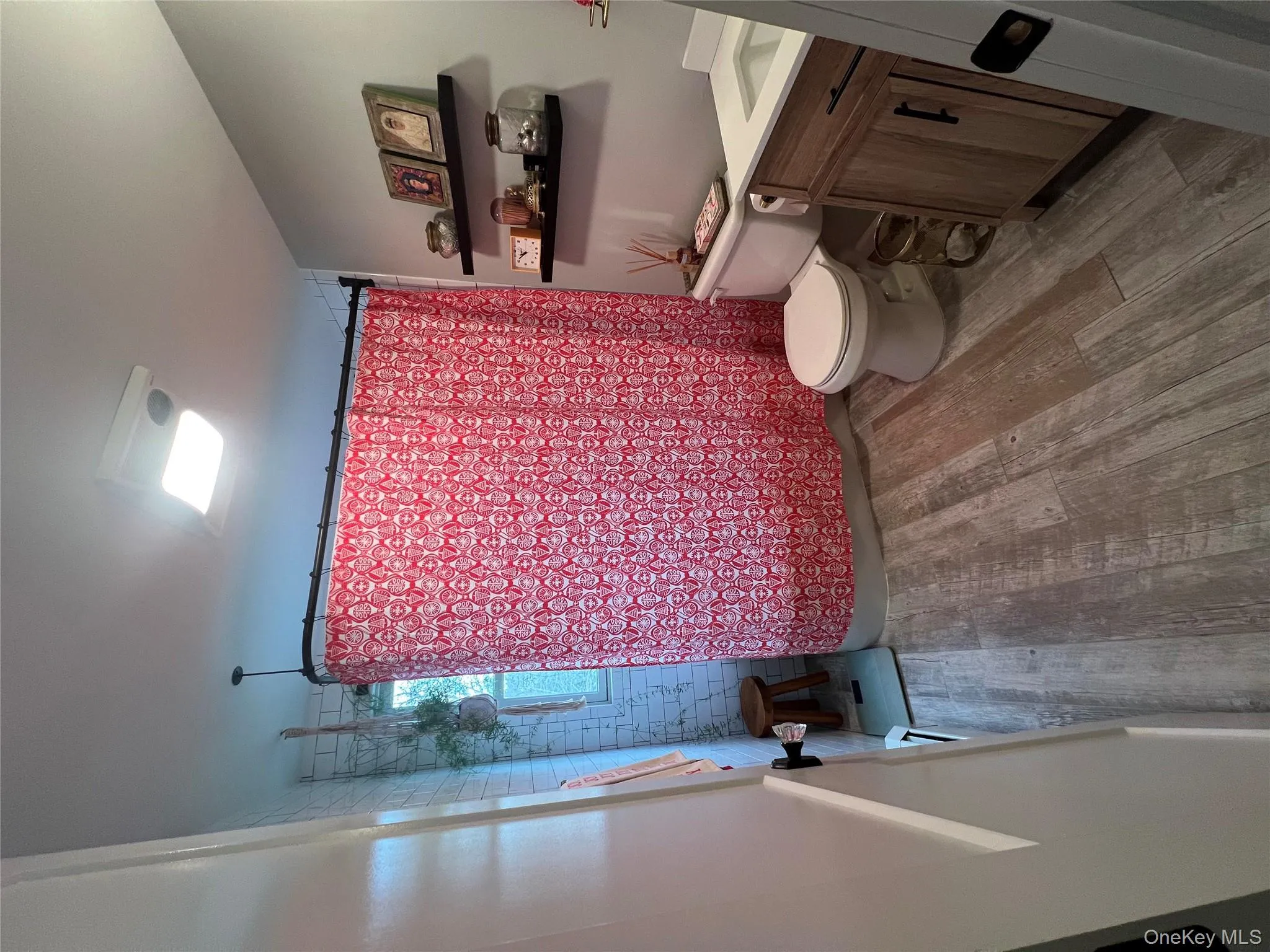 Full bathroom with vanity, light wood-type flooring, and shower / bath combo Full bathroom with vanity, light wood-type flooring, and shower / bath combo