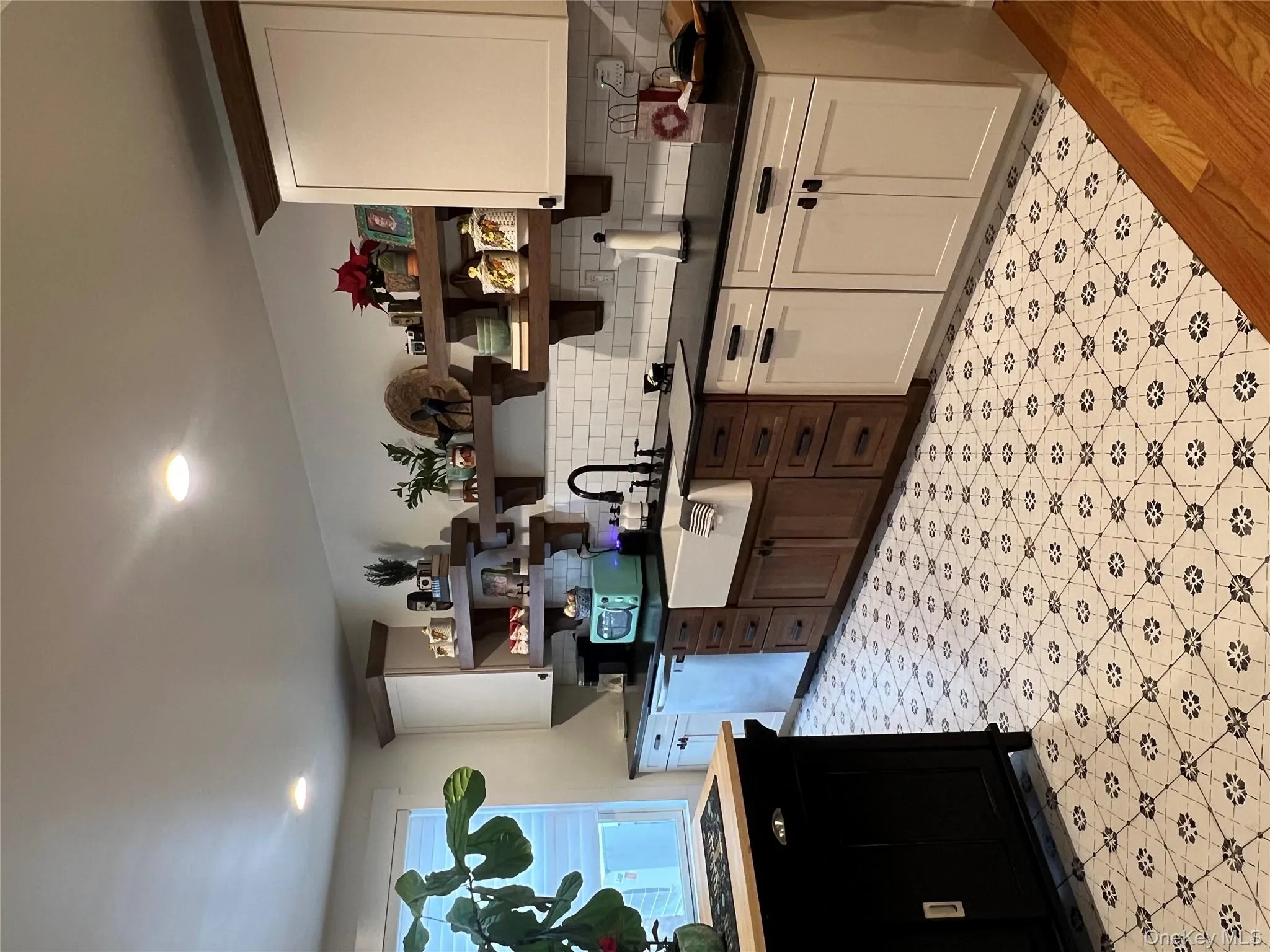 Kitchen featuring open shelves, backsplash, dishwasher, light floors, and stovetop Kitchen featuring open shelves, backsplash, dishwasher, light floors, and stovetop