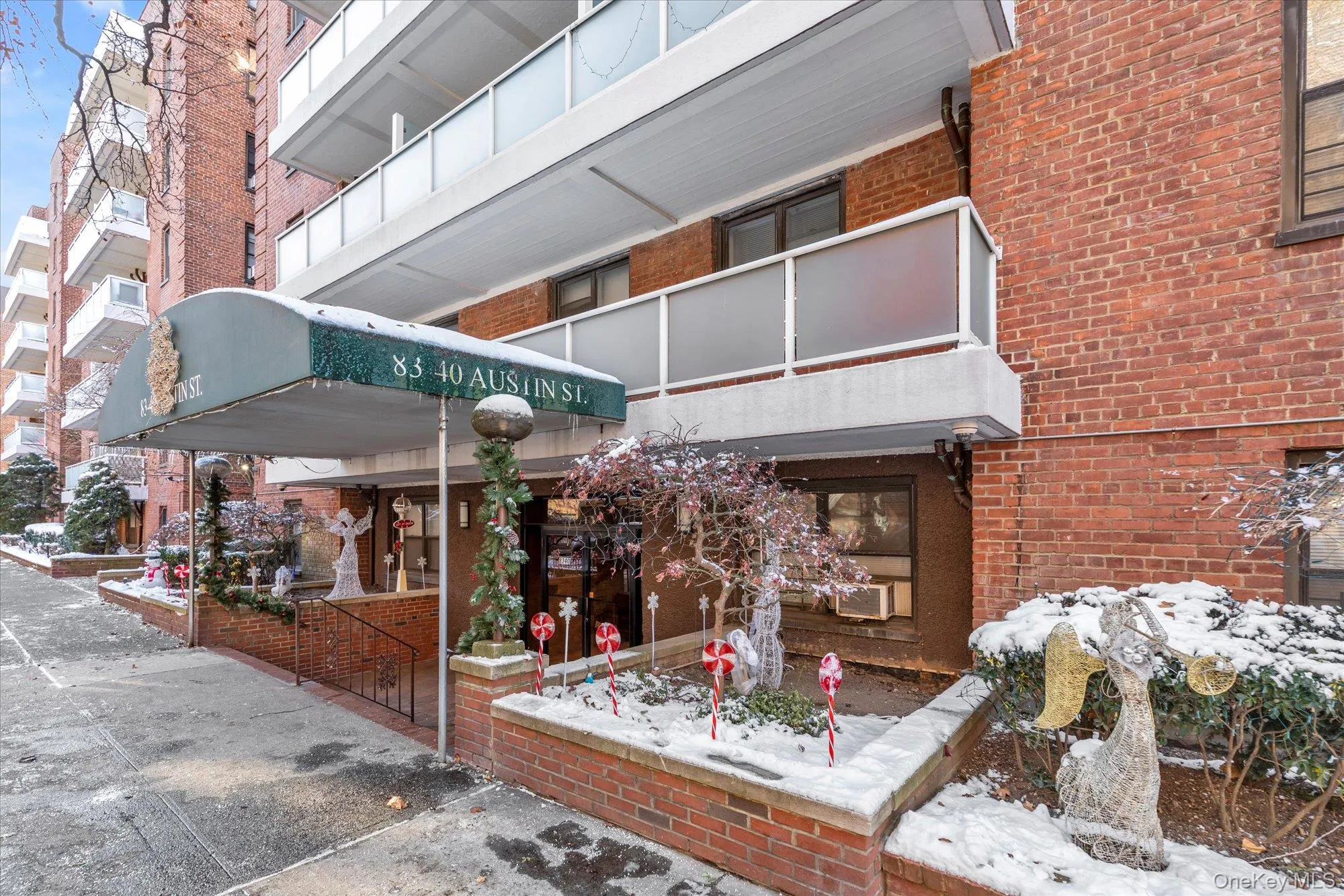 Snow covered building featuring a view of apartment building / complex and cooling unit Snow covered building featuring a view of apartment building / complex and cooling unit