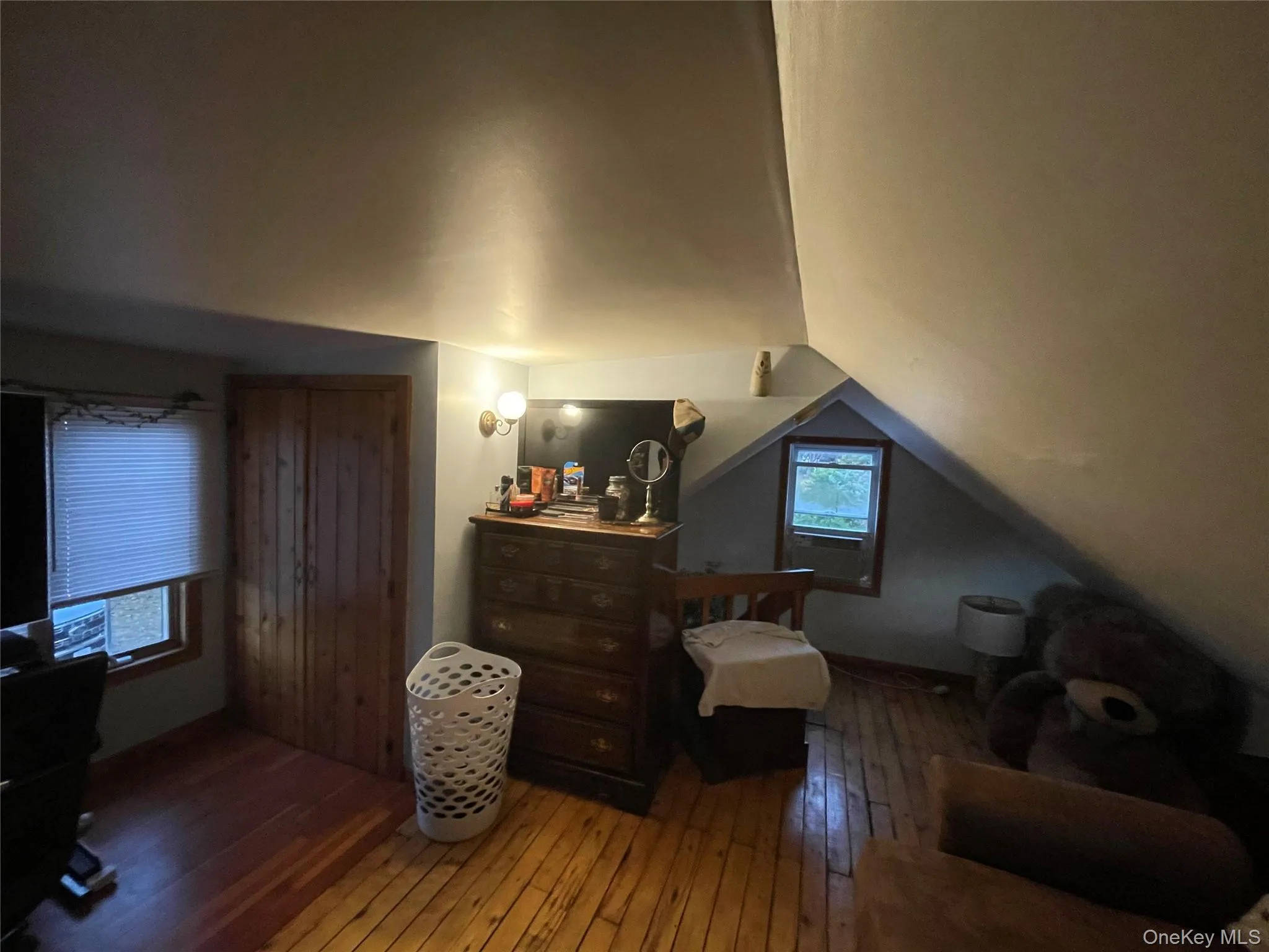 Bedroom with wood-type flooring and vaulted ceiling Bedroom with wood-type flooring and vaulted ceiling