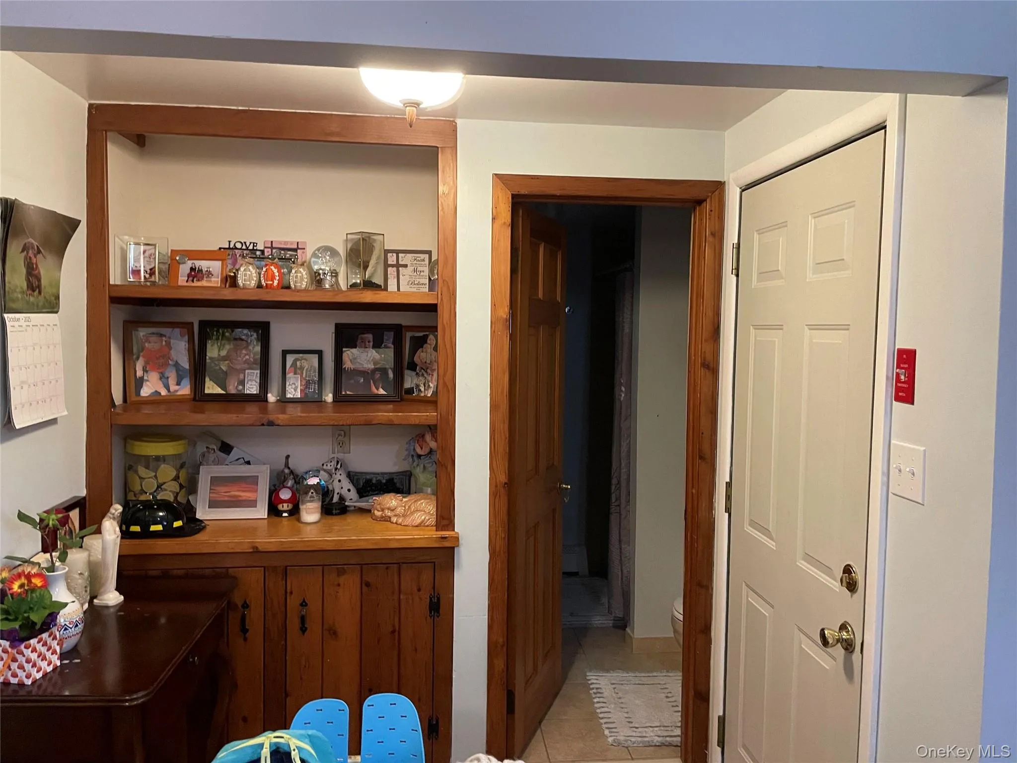 Shelf unit in kitchen with door to the bathroom Shelf unit in kitchen with door to the bathroom