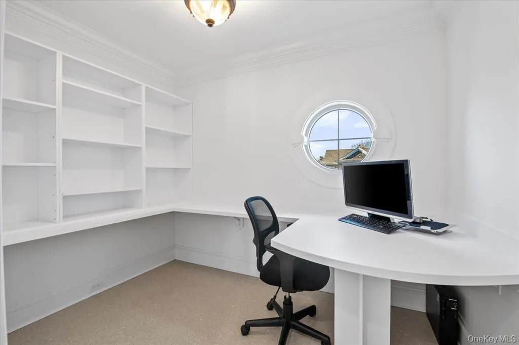 Unfurnished office featuring ornamental molding and baseboards Unfurnished office featuring ornamental molding and baseboards