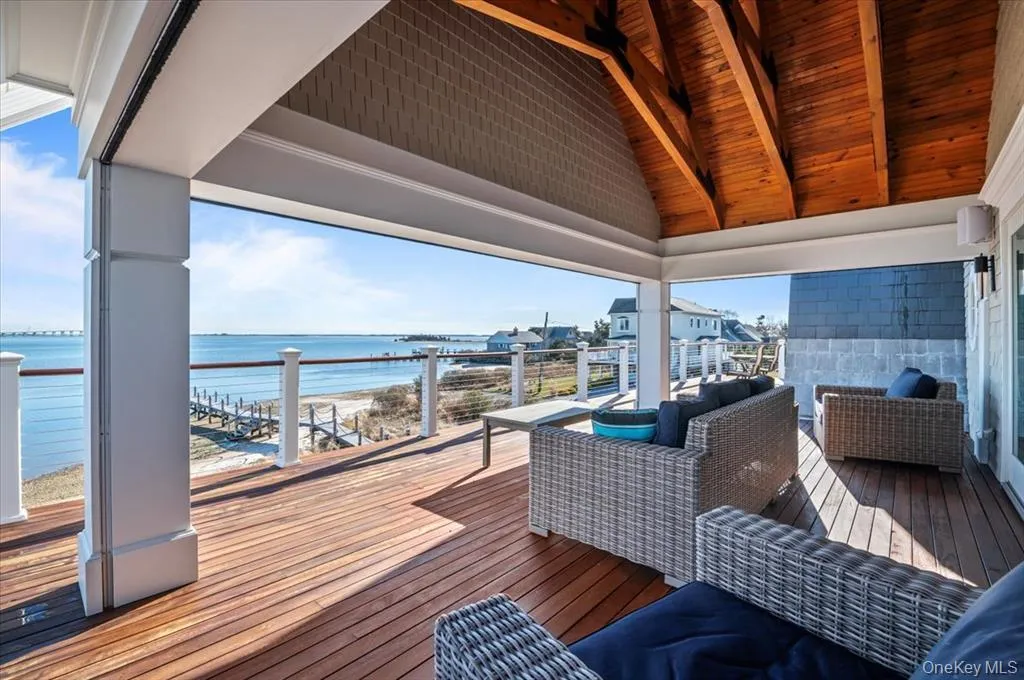 Wooden deck featuring a water view Wooden deck featuring a water view