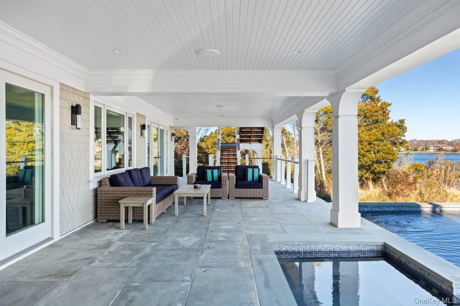 View of patio with an outdoor pool, an outdoor living space, and a water view View of patio with an outdoor pool, an outdoor living space, and a water view