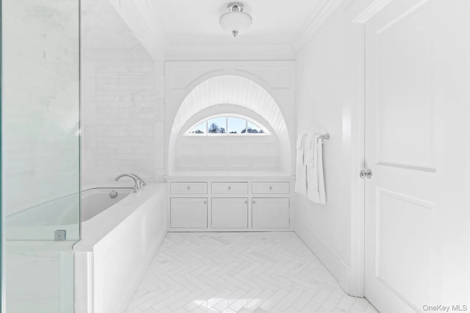 Bathroom featuring a bath and ornamental molding Bathroom featuring a bath and ornamental molding