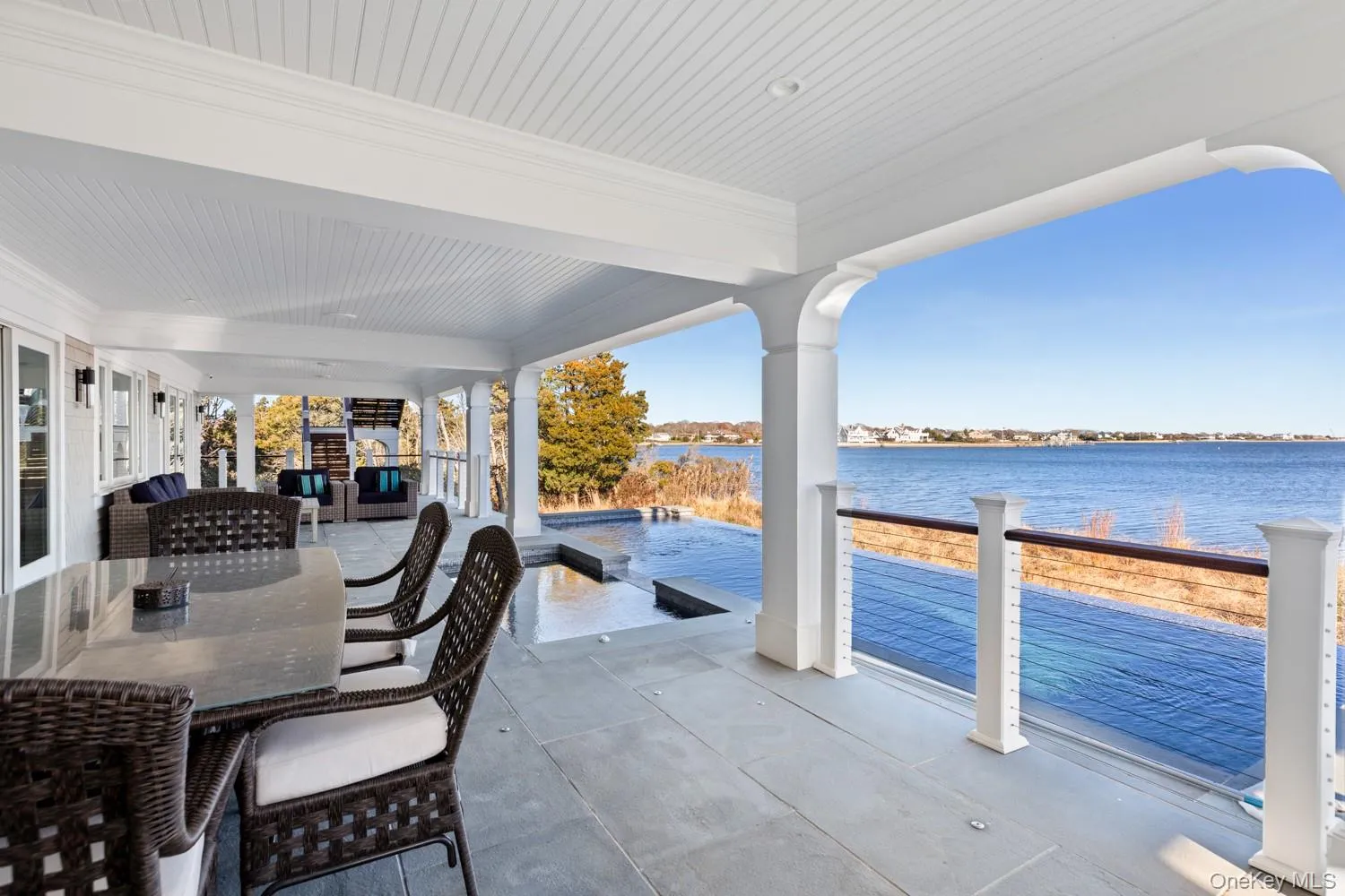 View of patio featuring a water view and outdoor dining space View of patio featuring a water view and outdoor dining space