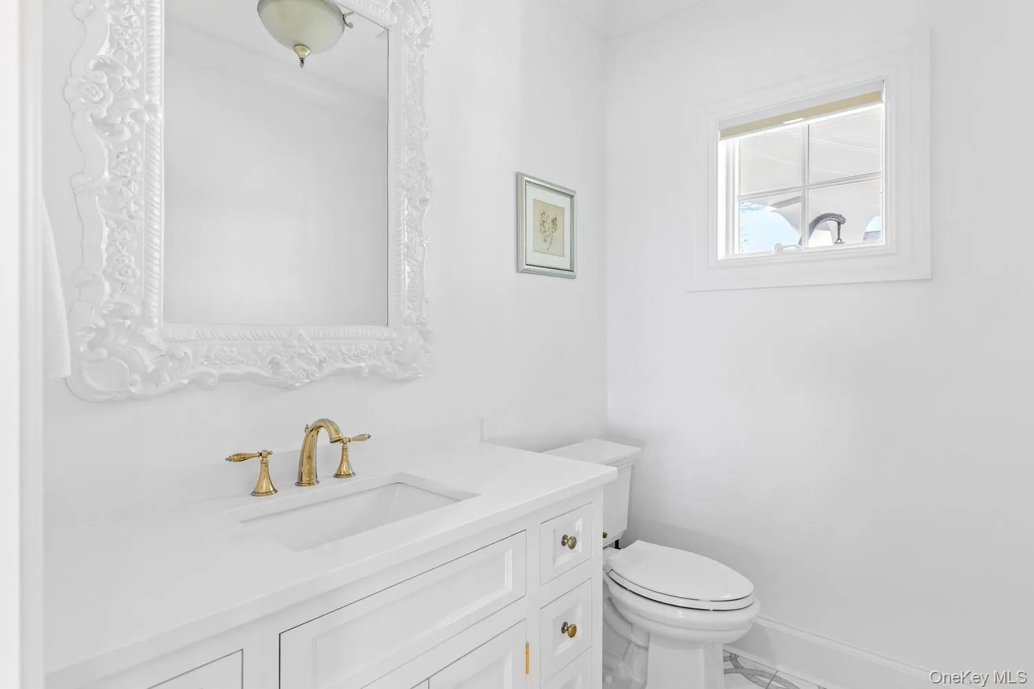 Half bathroom featuring vanity and marble look tile flooring Half bathroom featuring vanity and marble look tile flooring