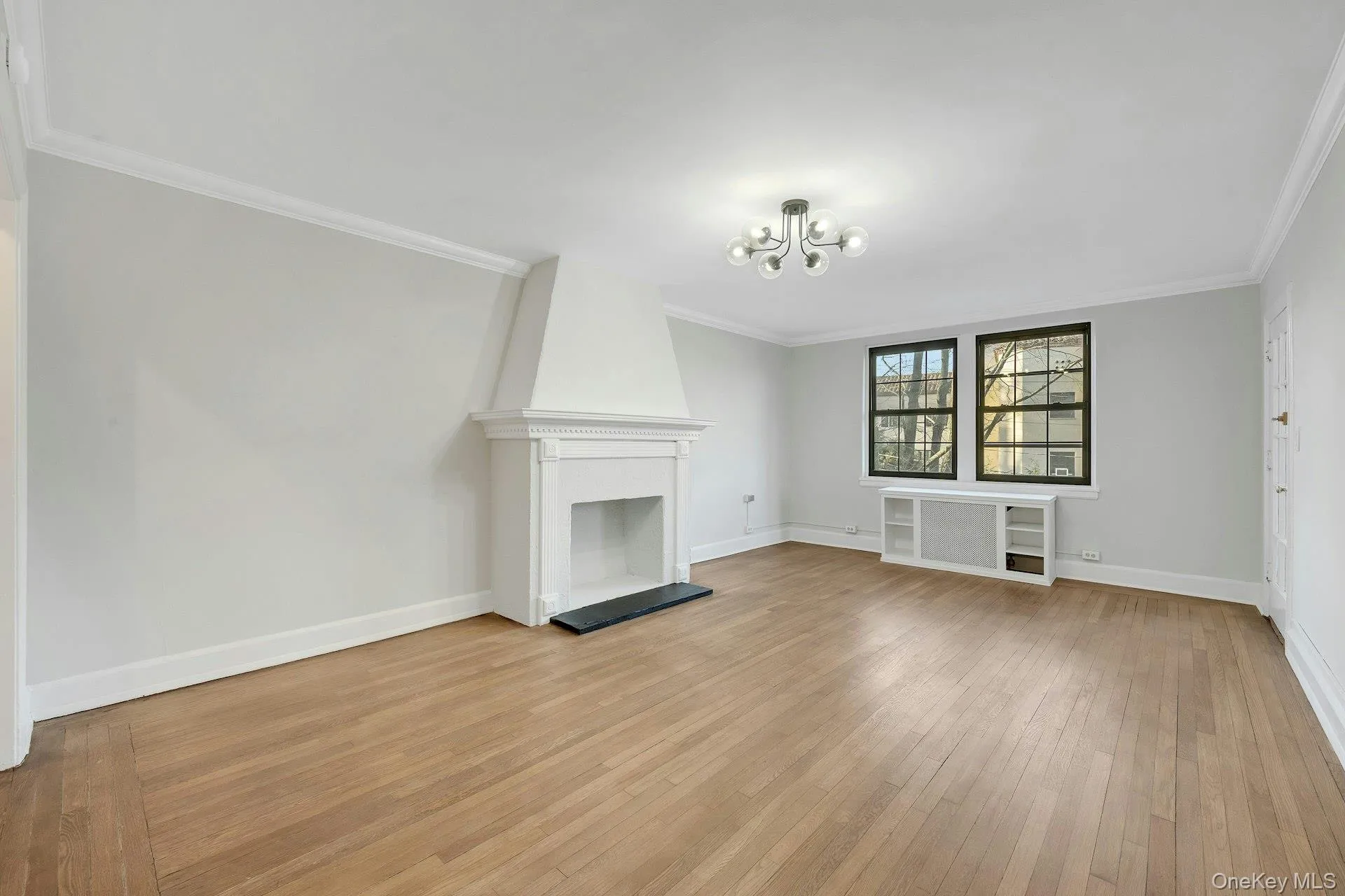 Living Room with Hardwood Flooring and Door to Screened in Terrace Living Room with Hardwood Flooring and Door to Screened in Terrace