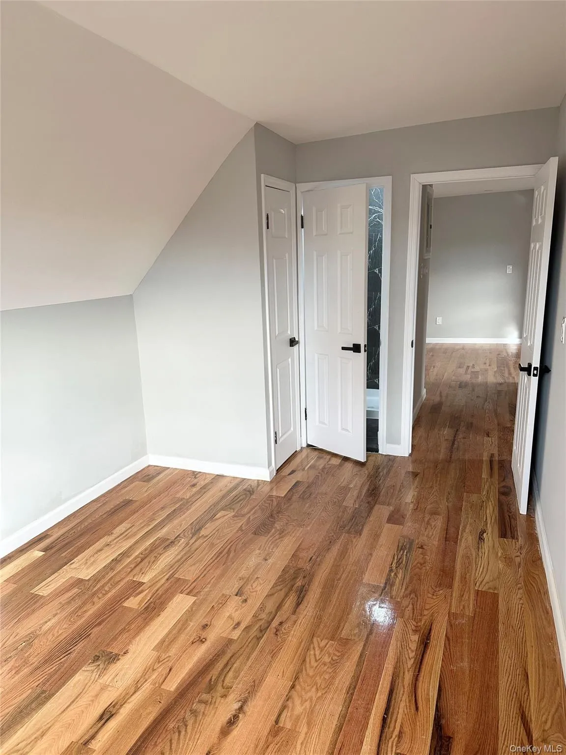 Bonus room featuring wood finished floors and lofted ceiling Bonus room featuring wood finished floors and lofted ceiling