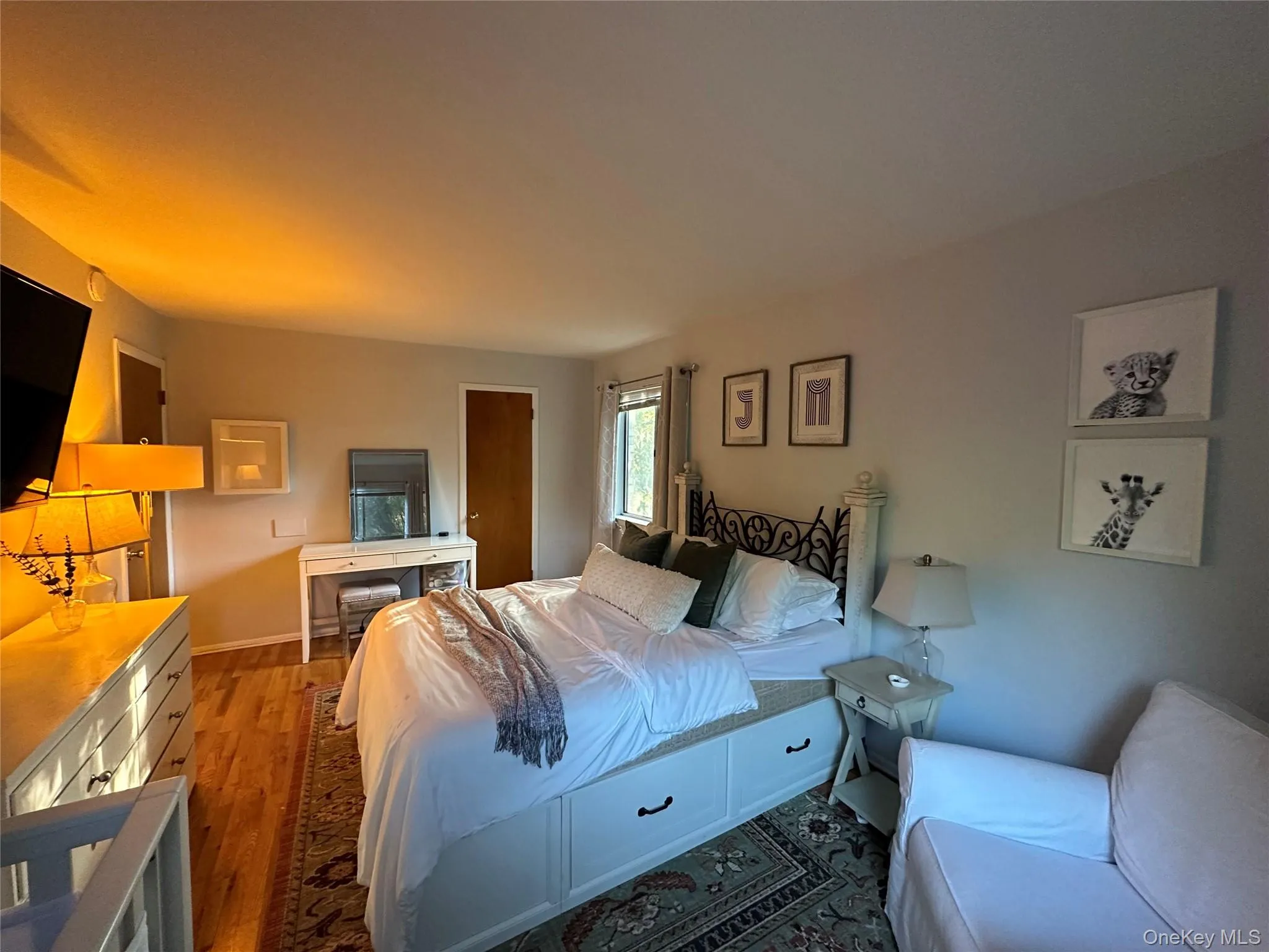 Bedroom featuring light wood-type flooring and baseboards Bedroom featuring light wood-type flooring and baseboards