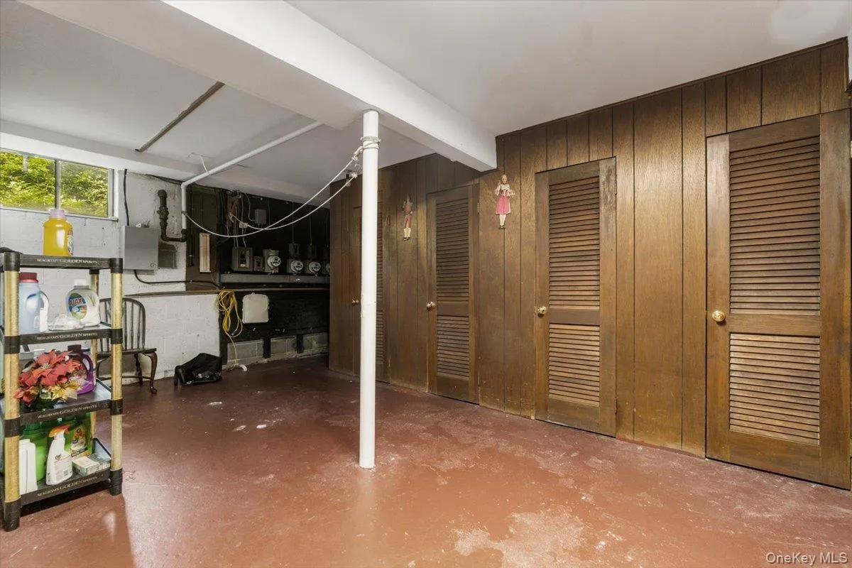 Below grade area featuring wood walls and electric panel Below grade area featuring wood walls and electric panel