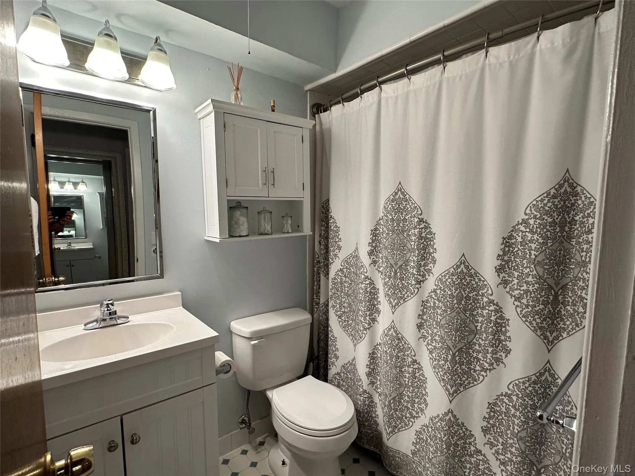 Full bath featuring a shower with shower curtain and vanity Full bath featuring a shower with shower curtain and vanity