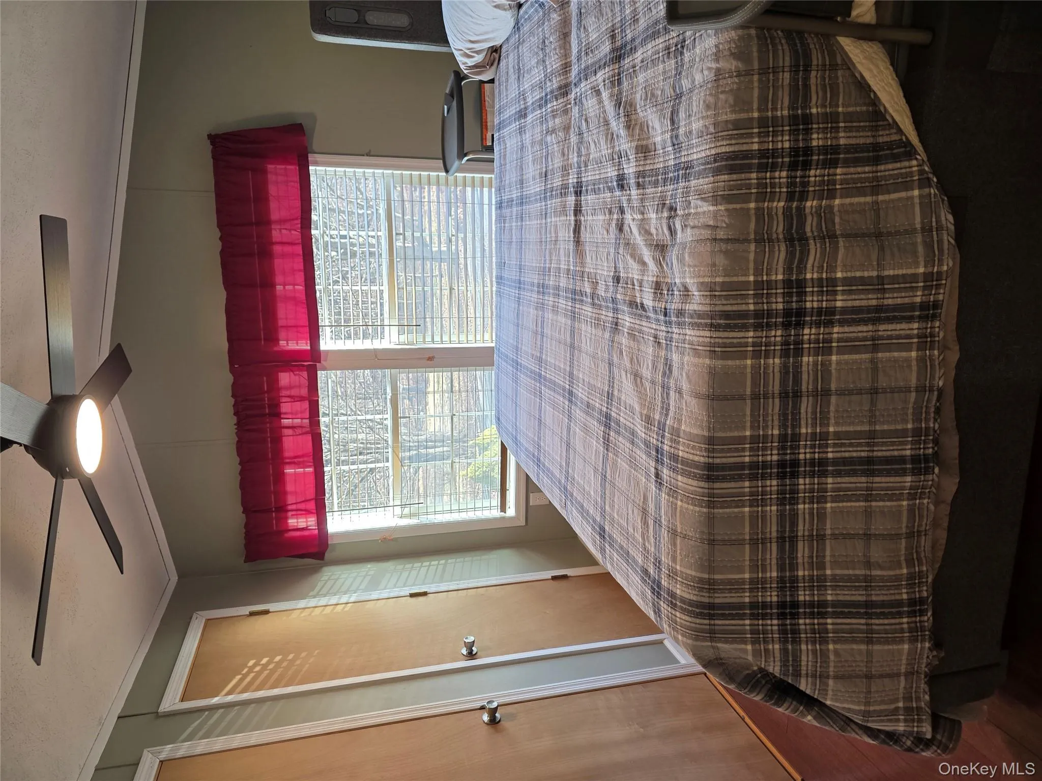 Bedroom featuring multiple closets, vaulted ceiling, multiple windows, ceiling fan, and crown molding Bedroom featuring multiple closets, vaulted ceiling, multiple windows, ceiling fan, and crown molding