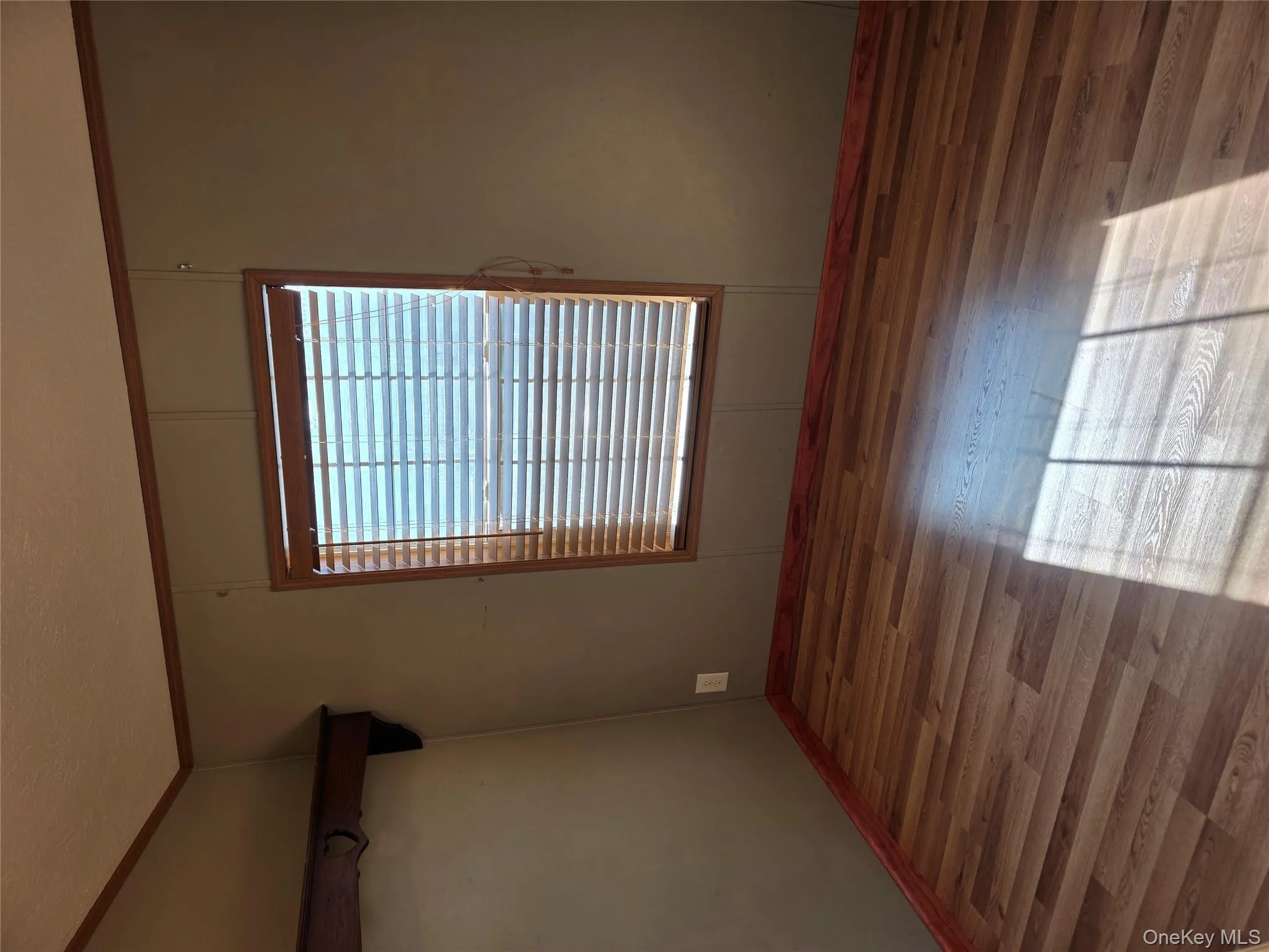 Spare room with wood finished floors and baseboards Spare room with wood finished floors and baseboards