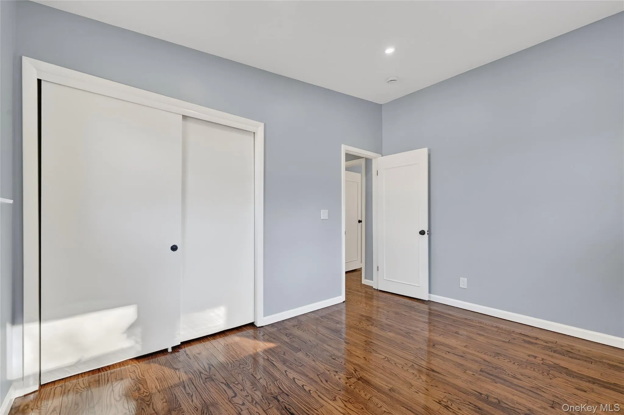 Unfurnished bedroom featuring a closet, dark wood-style floors, and recessed lighting Unfurnished bedroom featuring a closet, dark wood-style floors, and recessed lighting