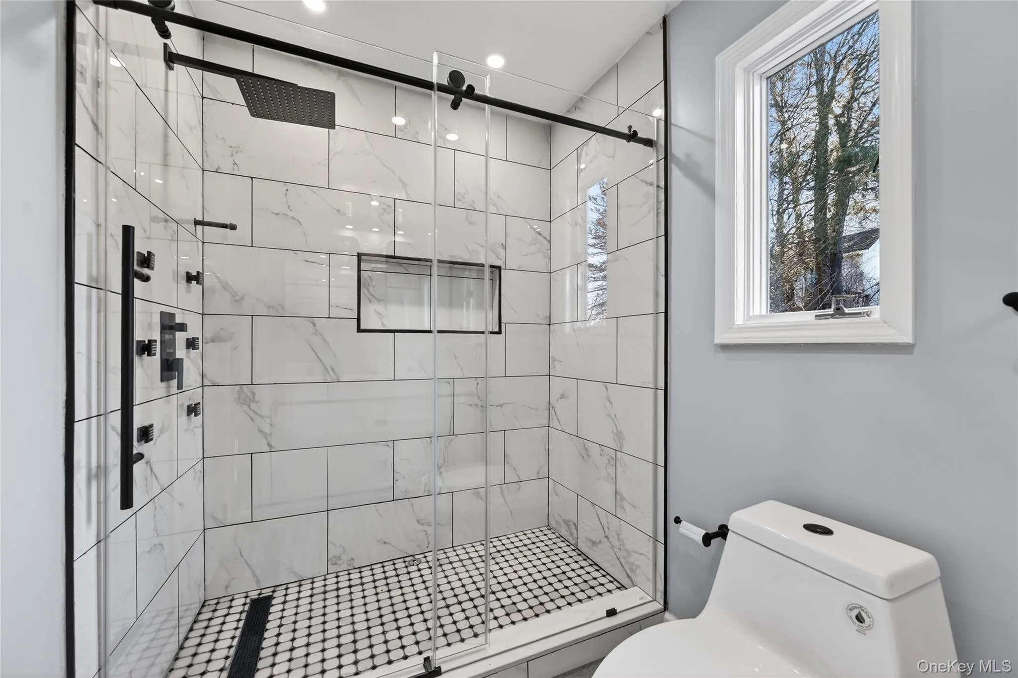 Bathroom with a marble finish shower Bathroom with a marble finish shower