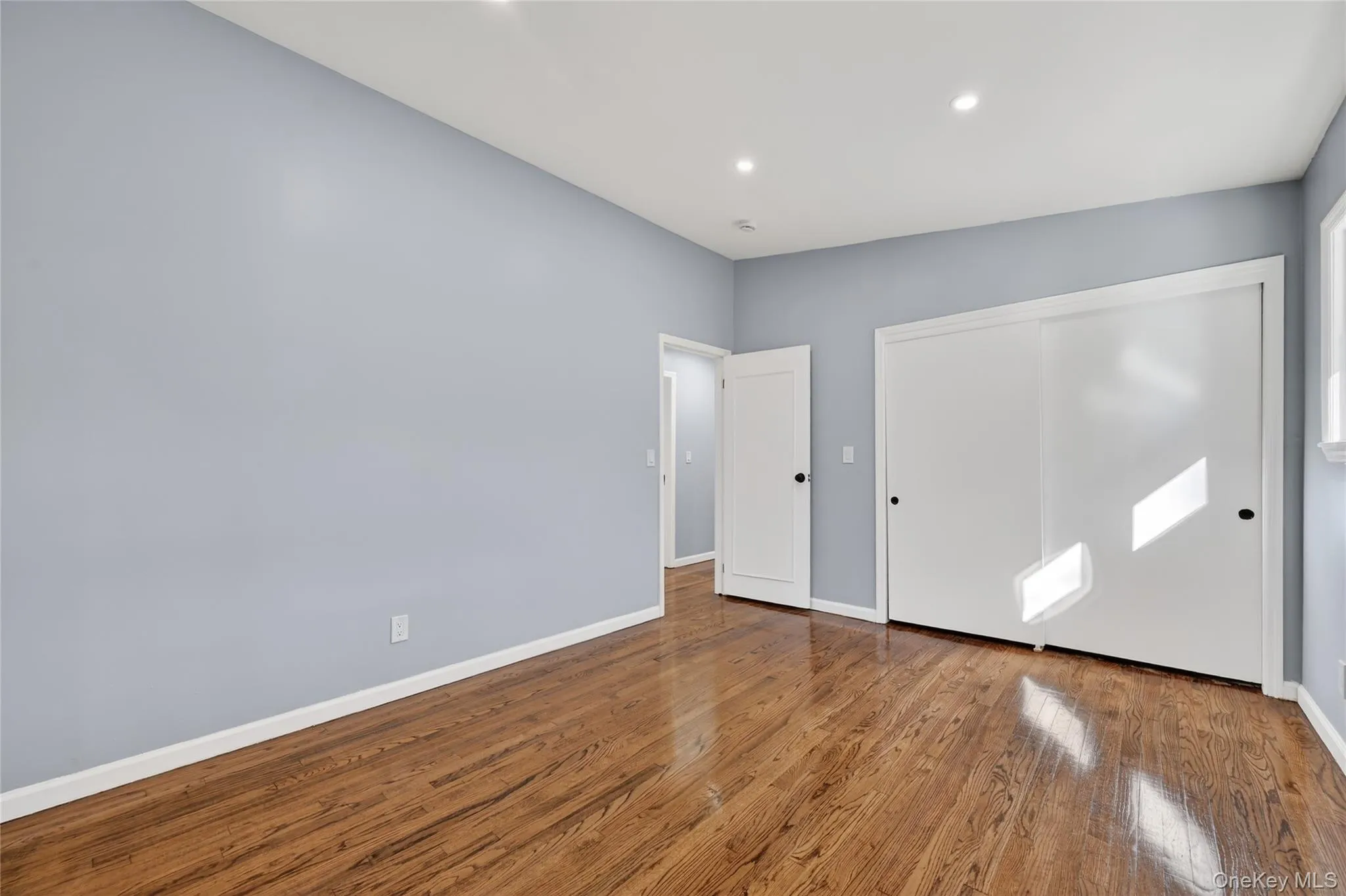 Unfurnished bedroom featuring hardwood / wood-style floors, recessed lighting, and a closet Unfurnished bedroom featuring hardwood / wood-style floors, recessed lighting, and a closet