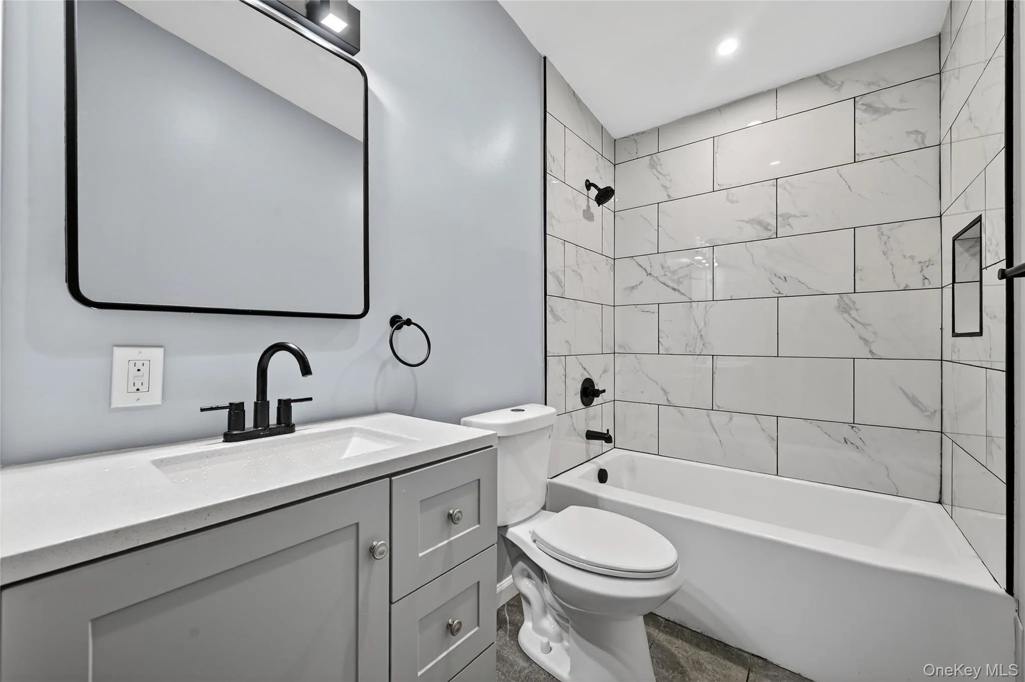 Bathroom featuring bathtub / shower combination and vanity Bathroom featuring bathtub / shower combination and vanity