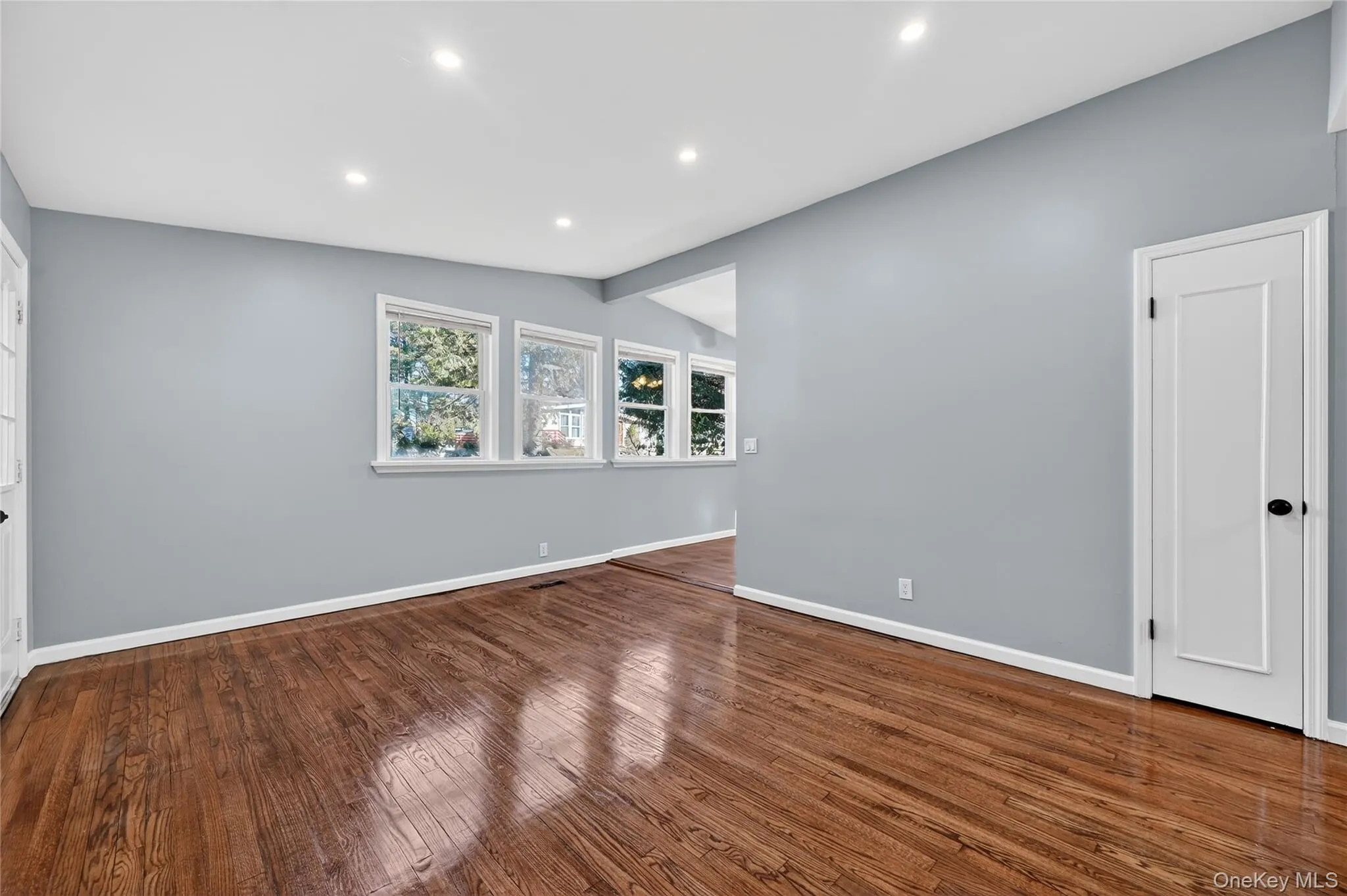 Unfurnished room featuring dark wood-type flooring, recessed lighting, and vaulted ceiling Unfurnished room featuring dark wood-type flooring, recessed lighting, and vaulted ceiling