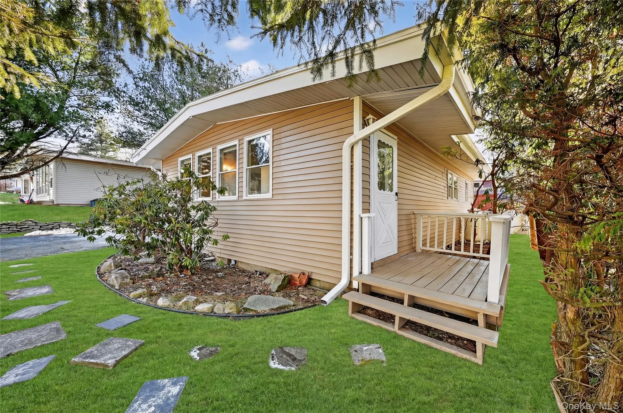View of side of property with a wooden deck and a lawn View of side of property with a wooden deck and a lawn