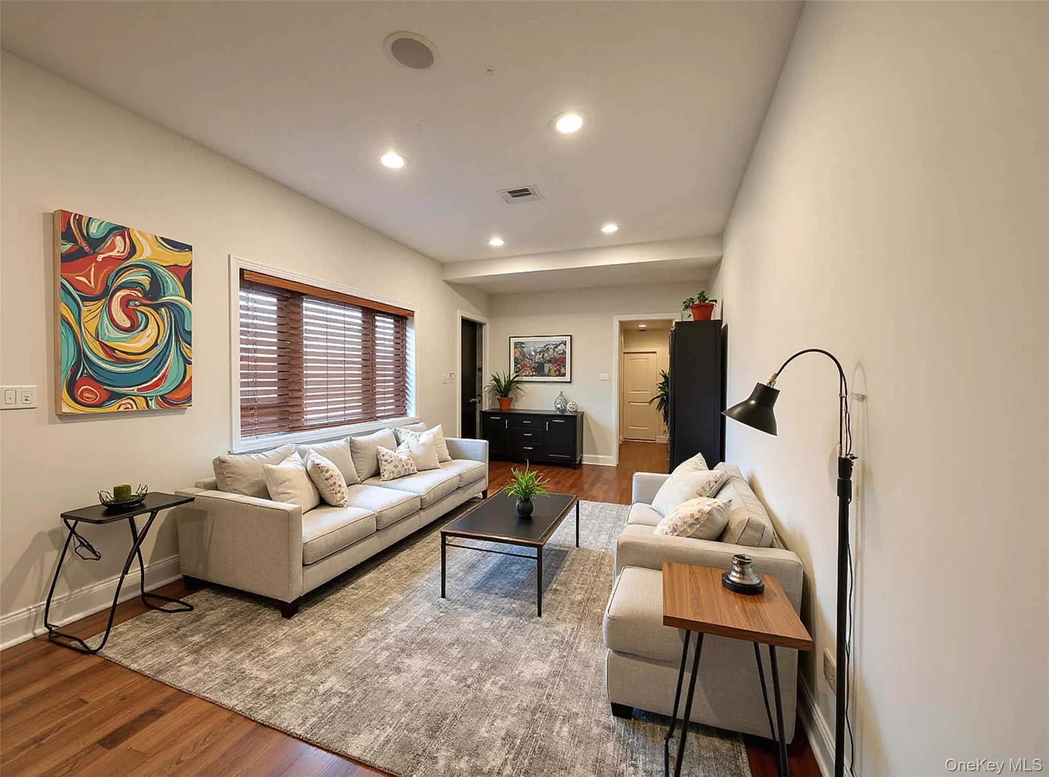 Living area featuring wood finished floors and recessed lighting Living area featuring wood finished floors and recessed lighting