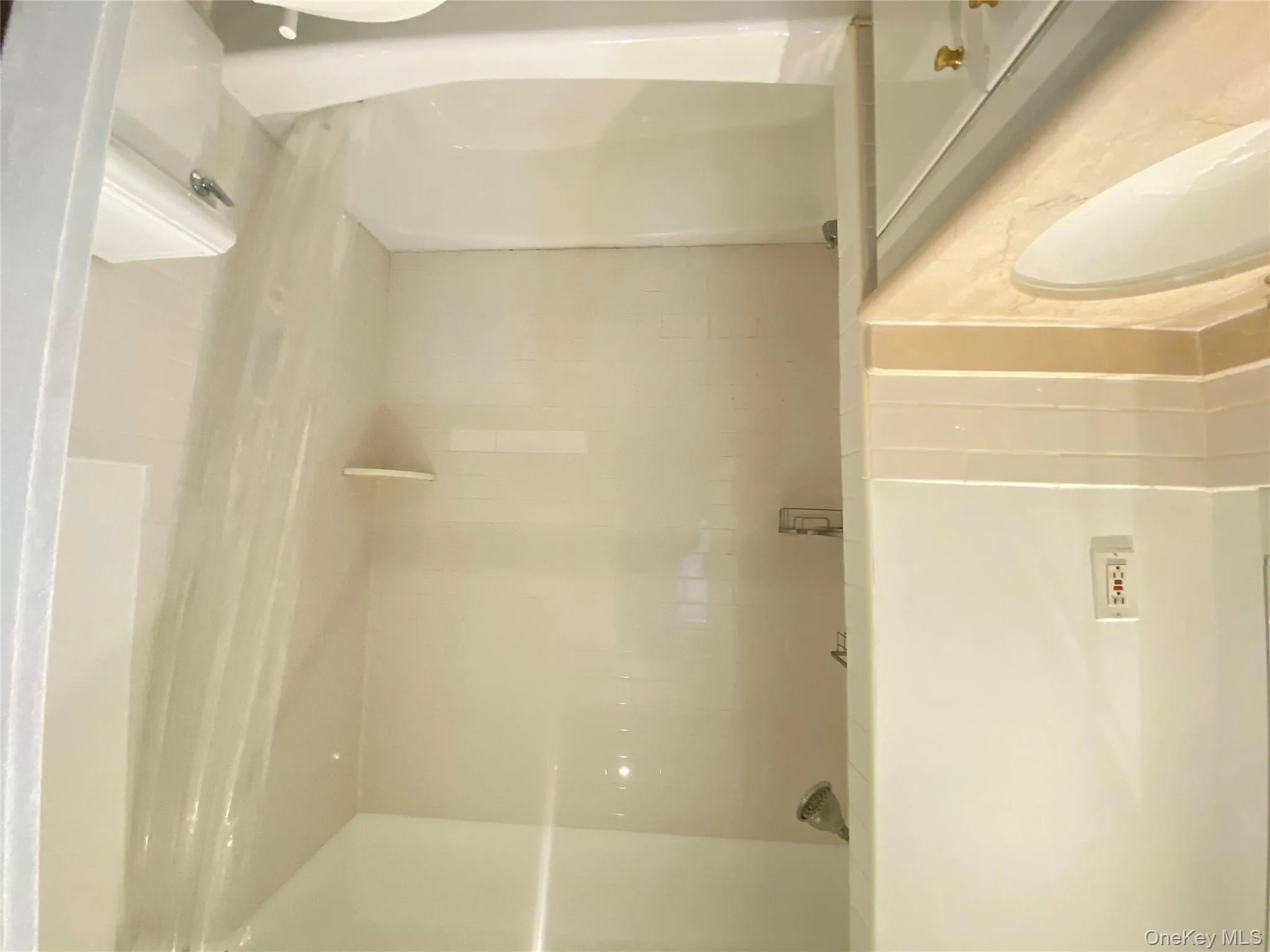 Bathroom featuring shower / tub combo and vanity, porcelain flooring, recessed lighting Bathroom featuring shower / tub combo and vanity, porcelain flooring, recessed lighting