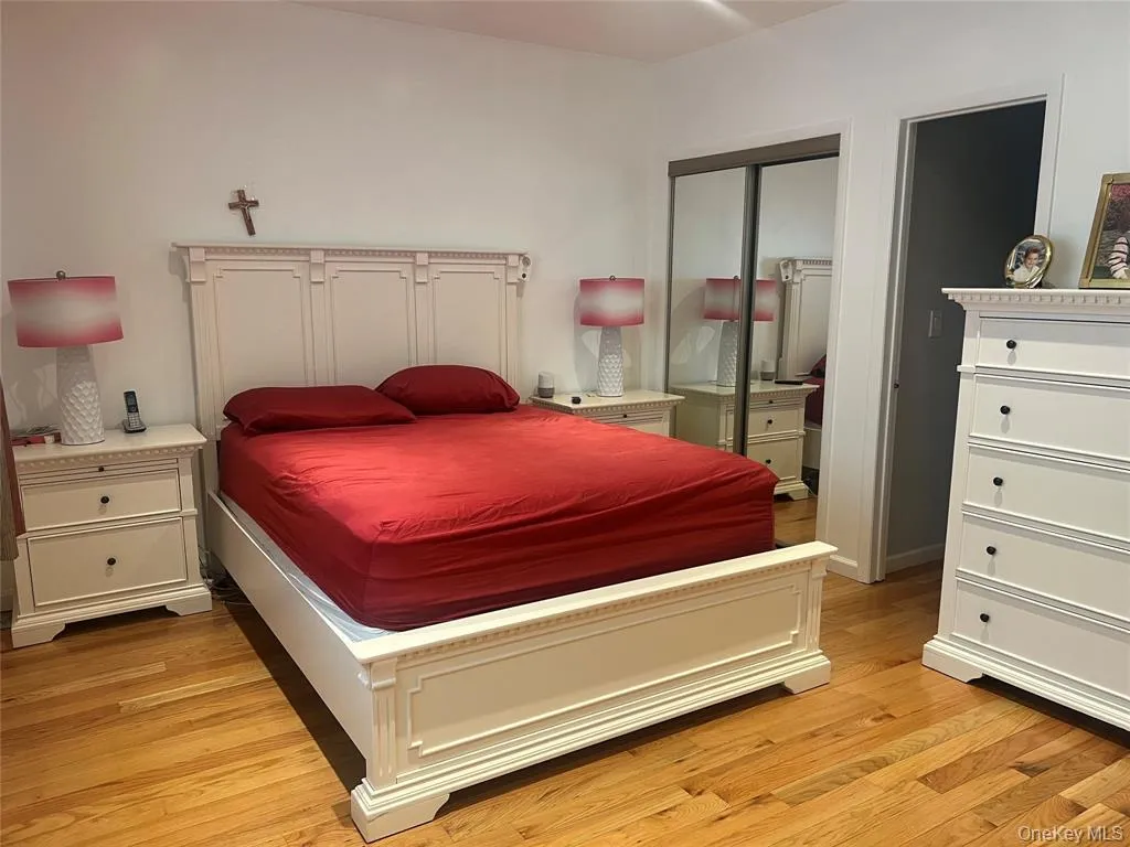 Bedroom featuring a closet and light wood-style floors Bedroom featuring a closet and light wood-style floors