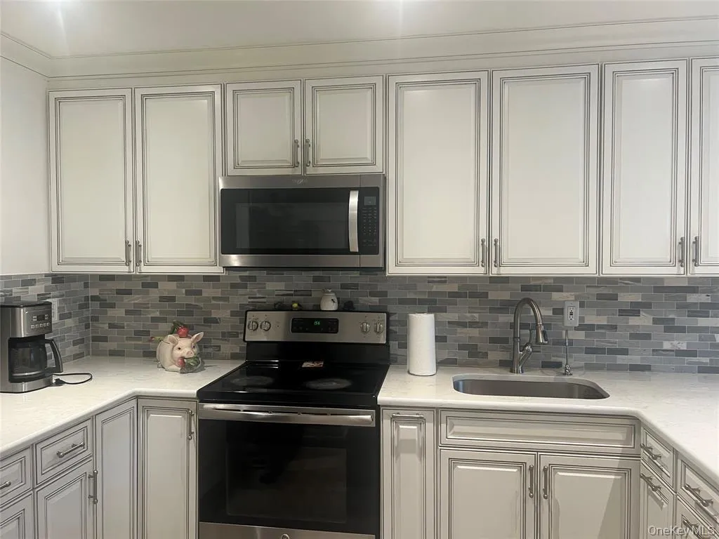 Kitchen with stainless steel appliances and white cabinets Kitchen with stainless steel appliances and white cabinets