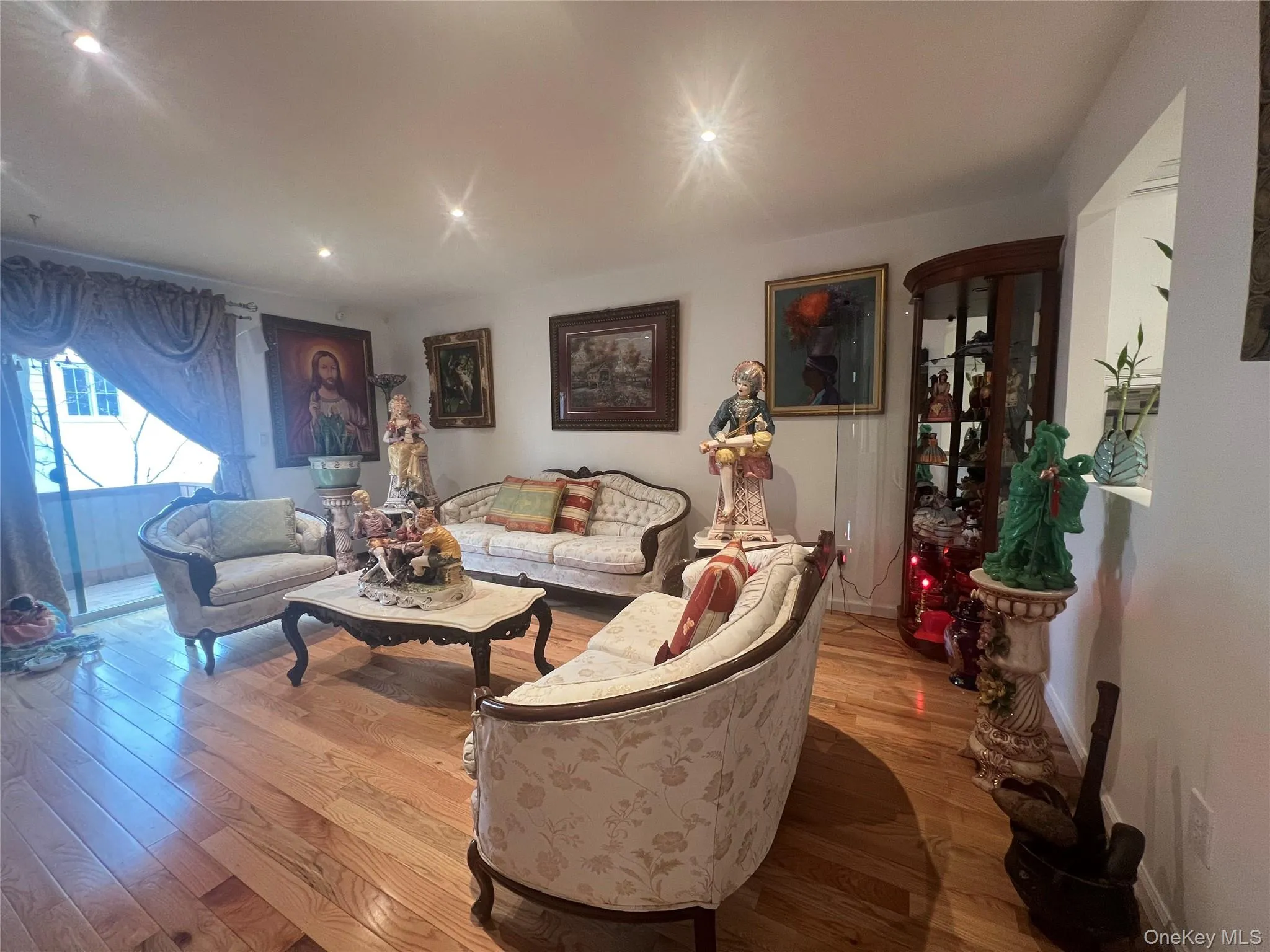 Living room featuring wood finished floors and recessed lighting Living room featuring wood finished floors and recessed lighting