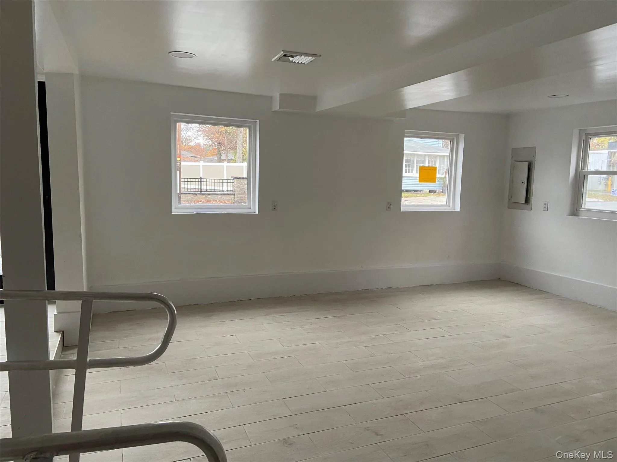Spare room featuring electric panel and light wood-type flooring Spare room featuring electric panel and light wood-type flooring
