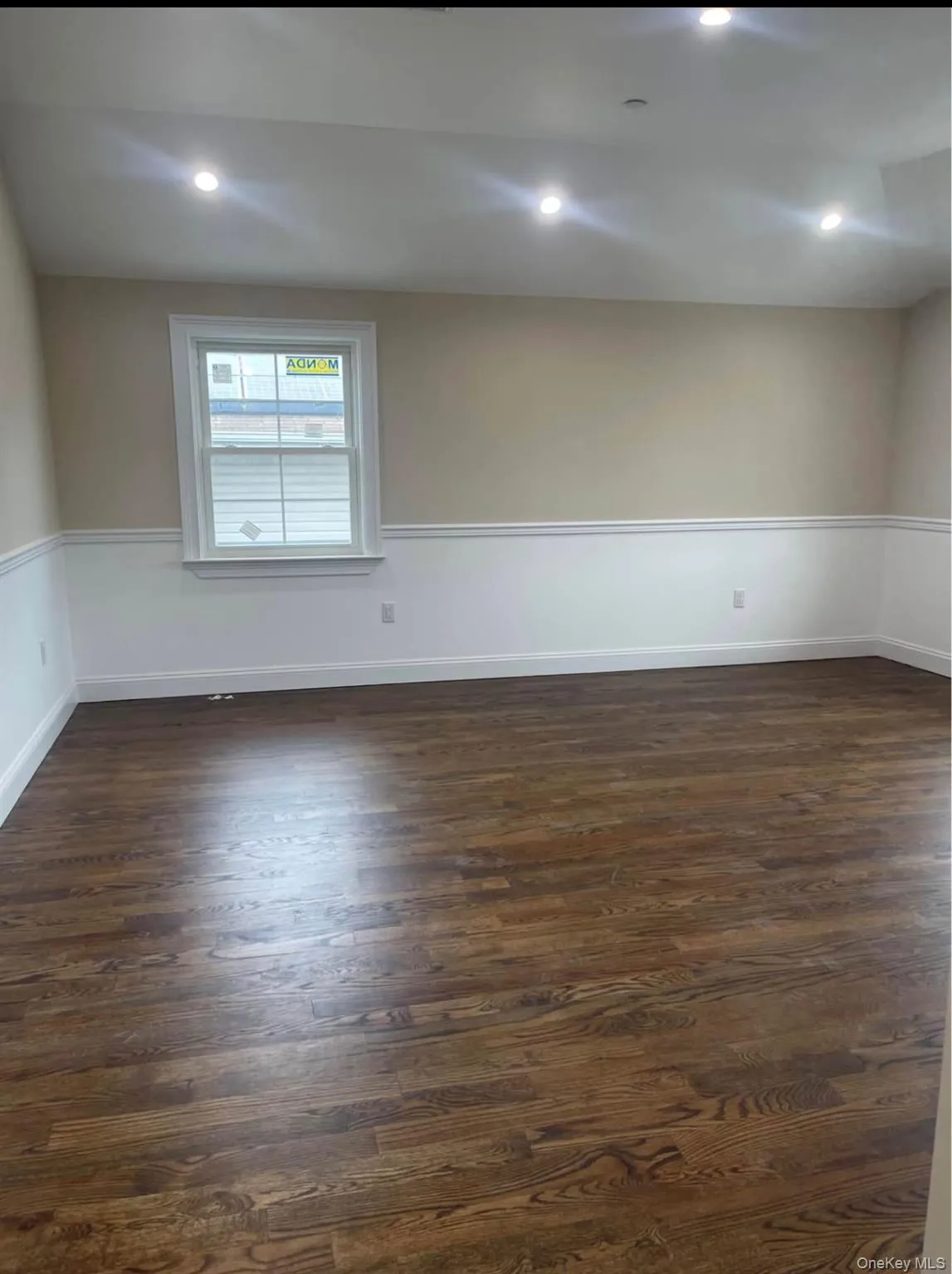 Empty room with dark wood-style floors and recessed lighting Empty room with dark wood-style floors and recessed lighting